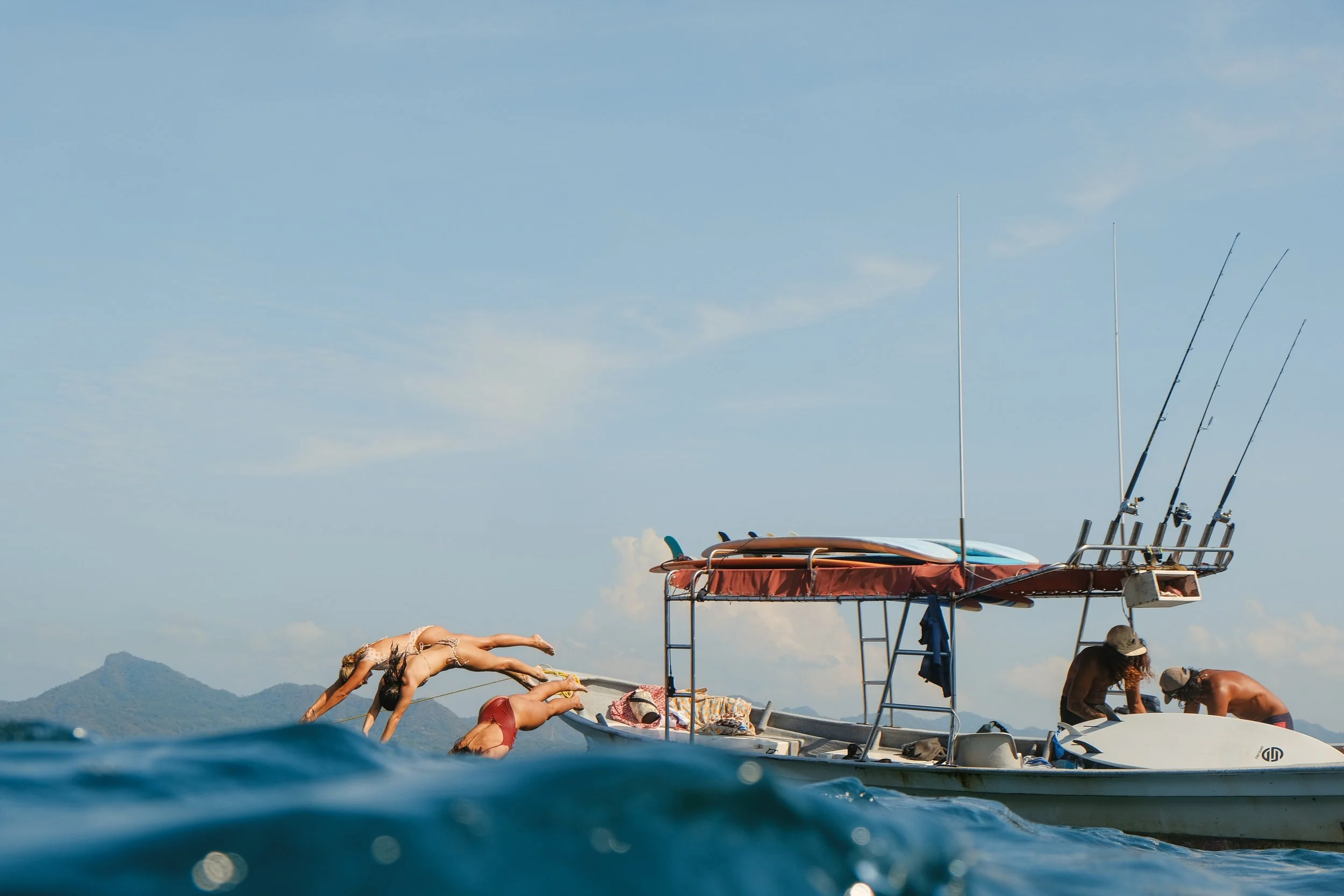 Our iconic boat day- surf a secluded surf break, whale watch, snorkel + fish!