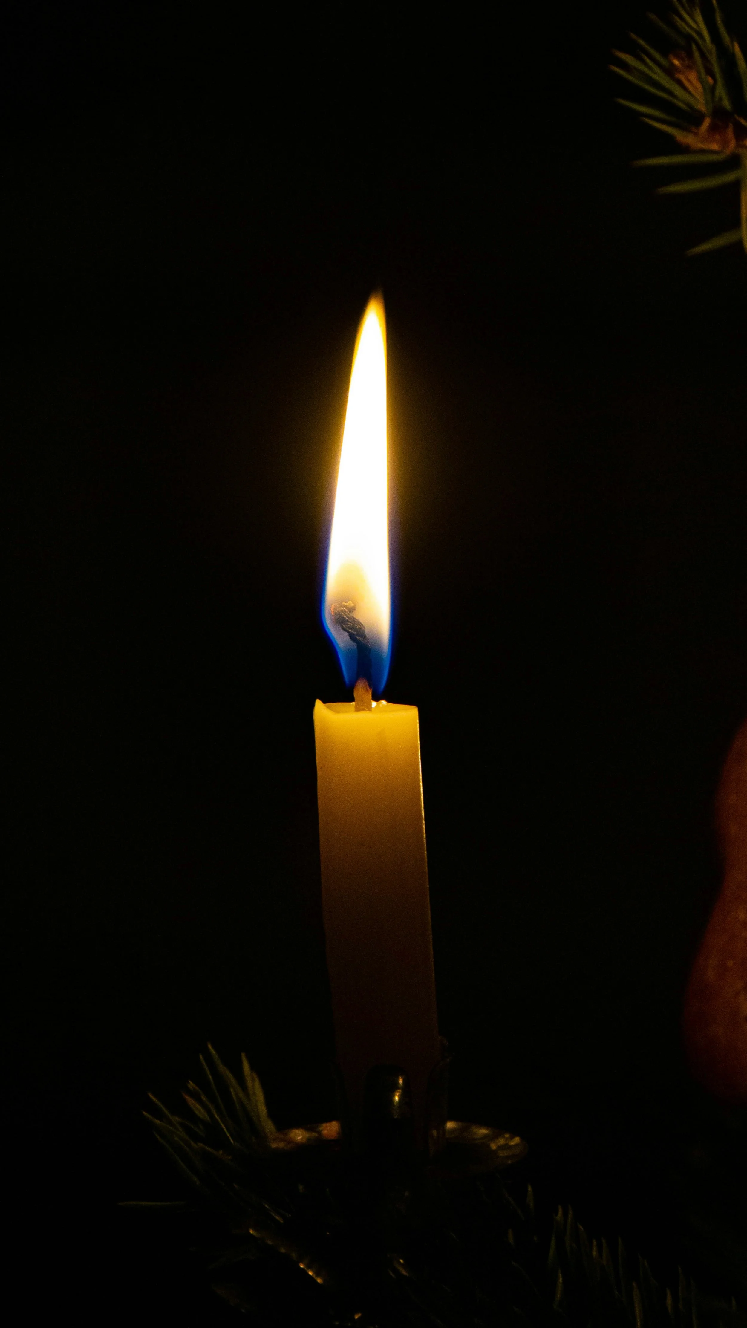 lit candle black background