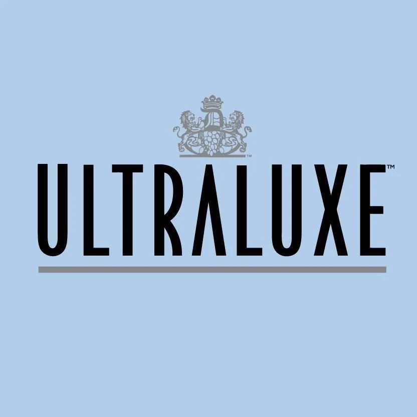 Logo with a crown and lion illustration above the word ULTRALUXE on a light blue background.