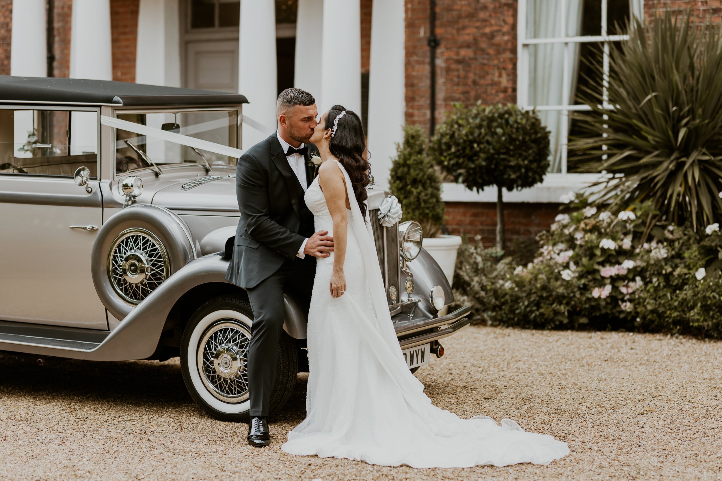  Bride and groom with wedding car outside of Bawtry Hall 
