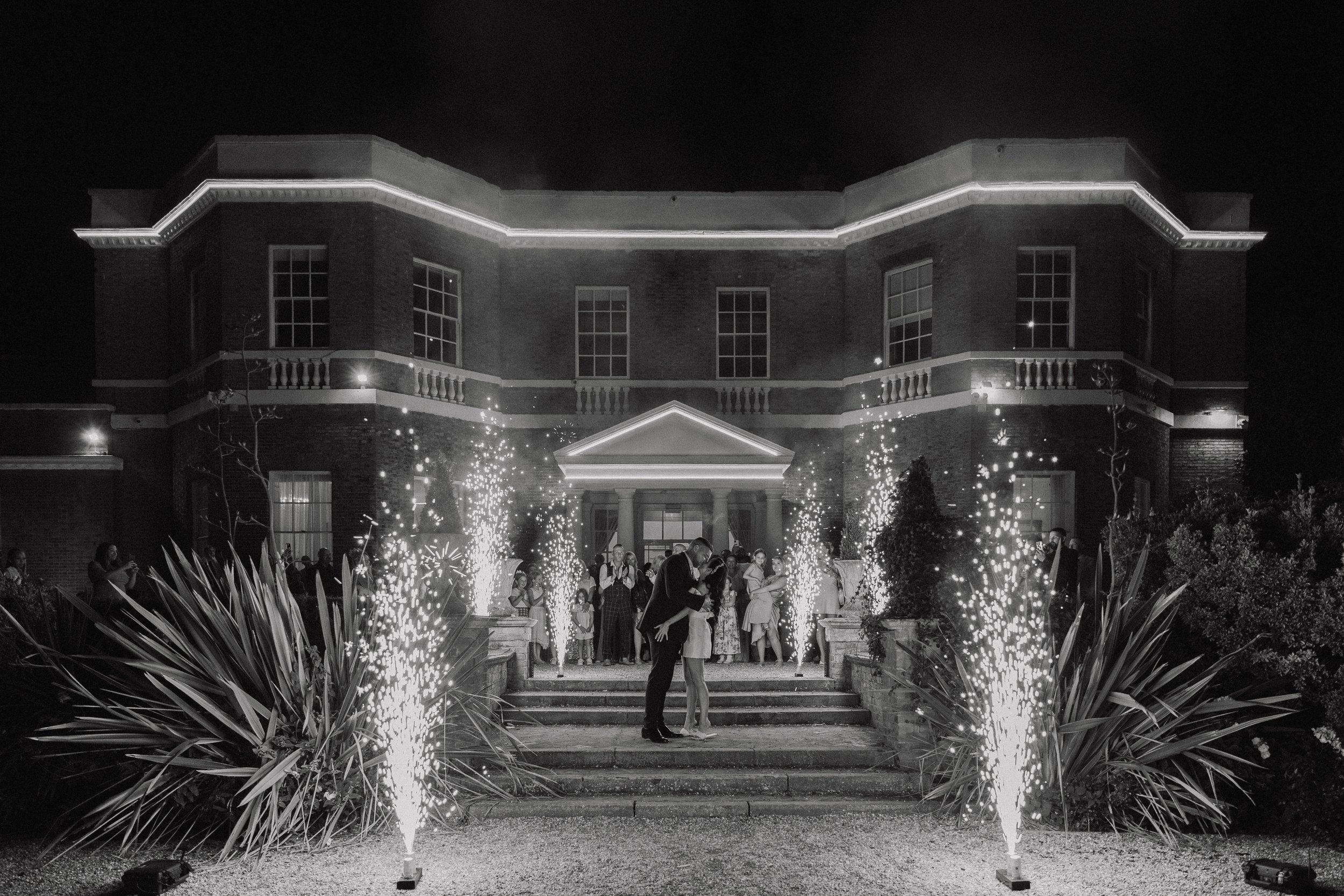  Newlyweds kissing during fireworks on wedding day at Bawtry Hall 
