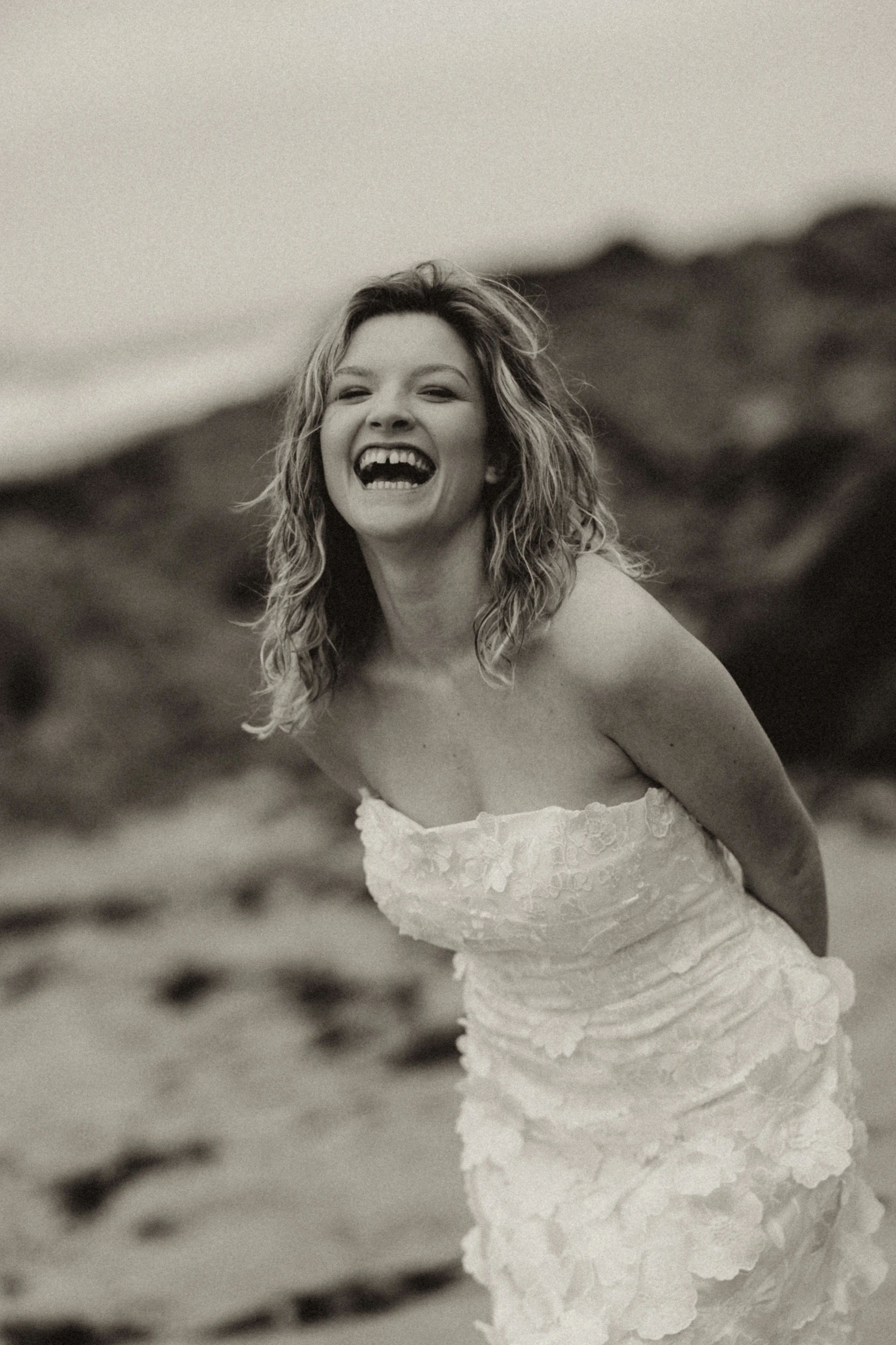 Bridal portrait in Cornwall with loose beach hair, natural makeup, and a relaxed, fashion-inspired feel