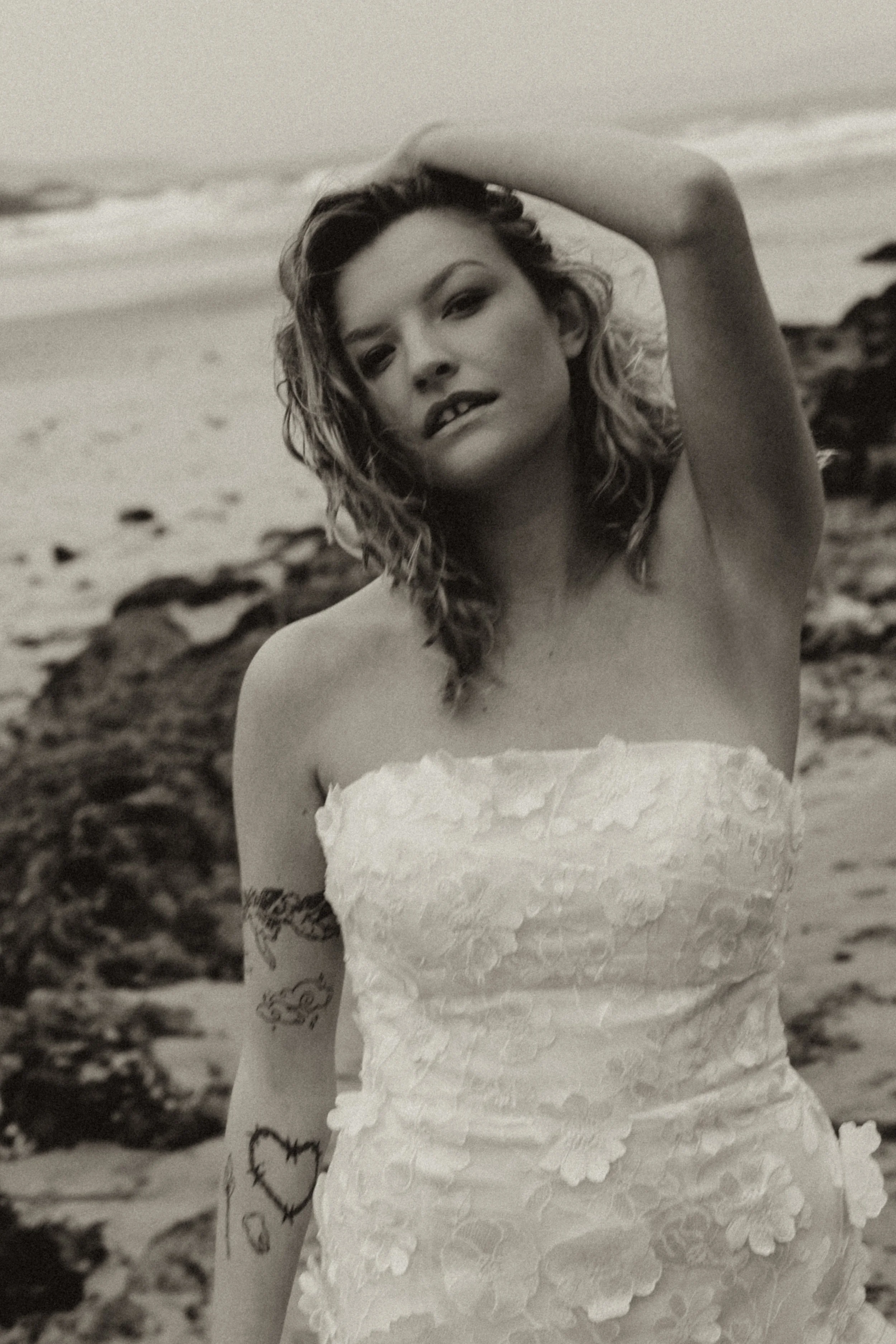 Bridal detail shot with wind-swept hair and subtle textures in an editorial wedding photography style