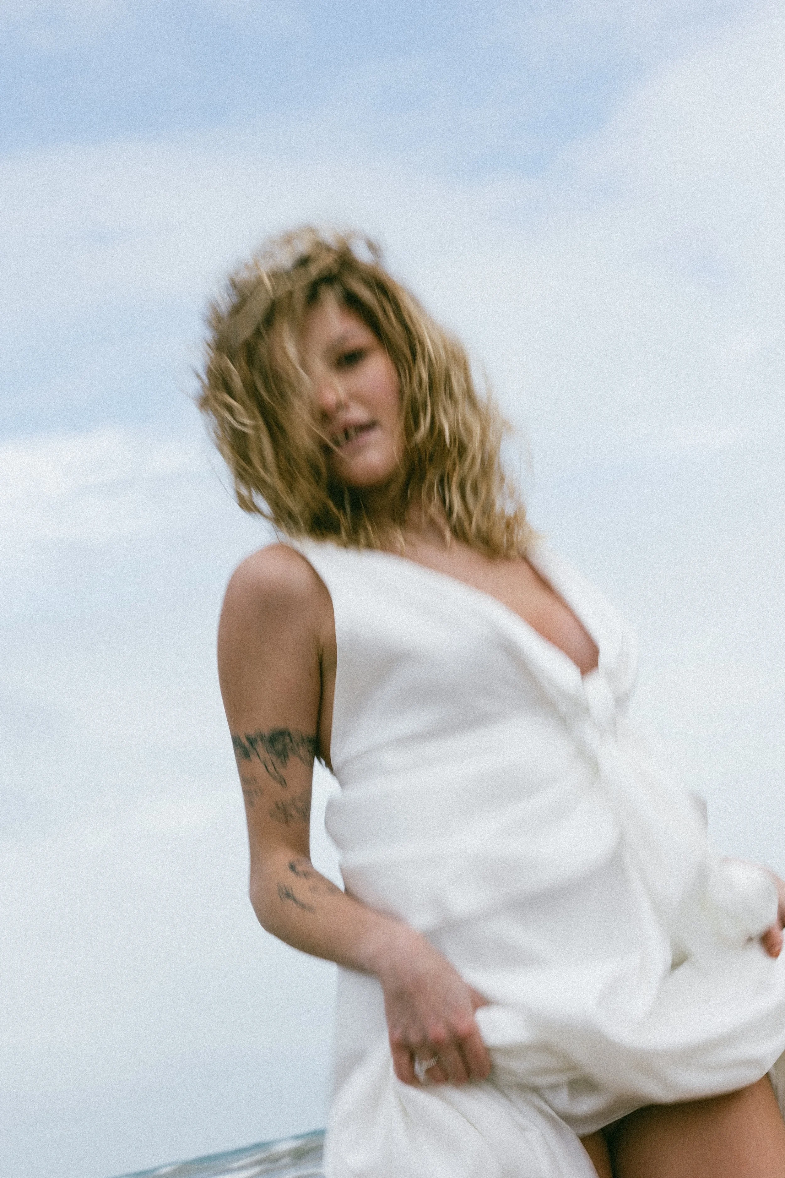 Grainy, film-style bridal editorial image with soft tones and natural imperfections