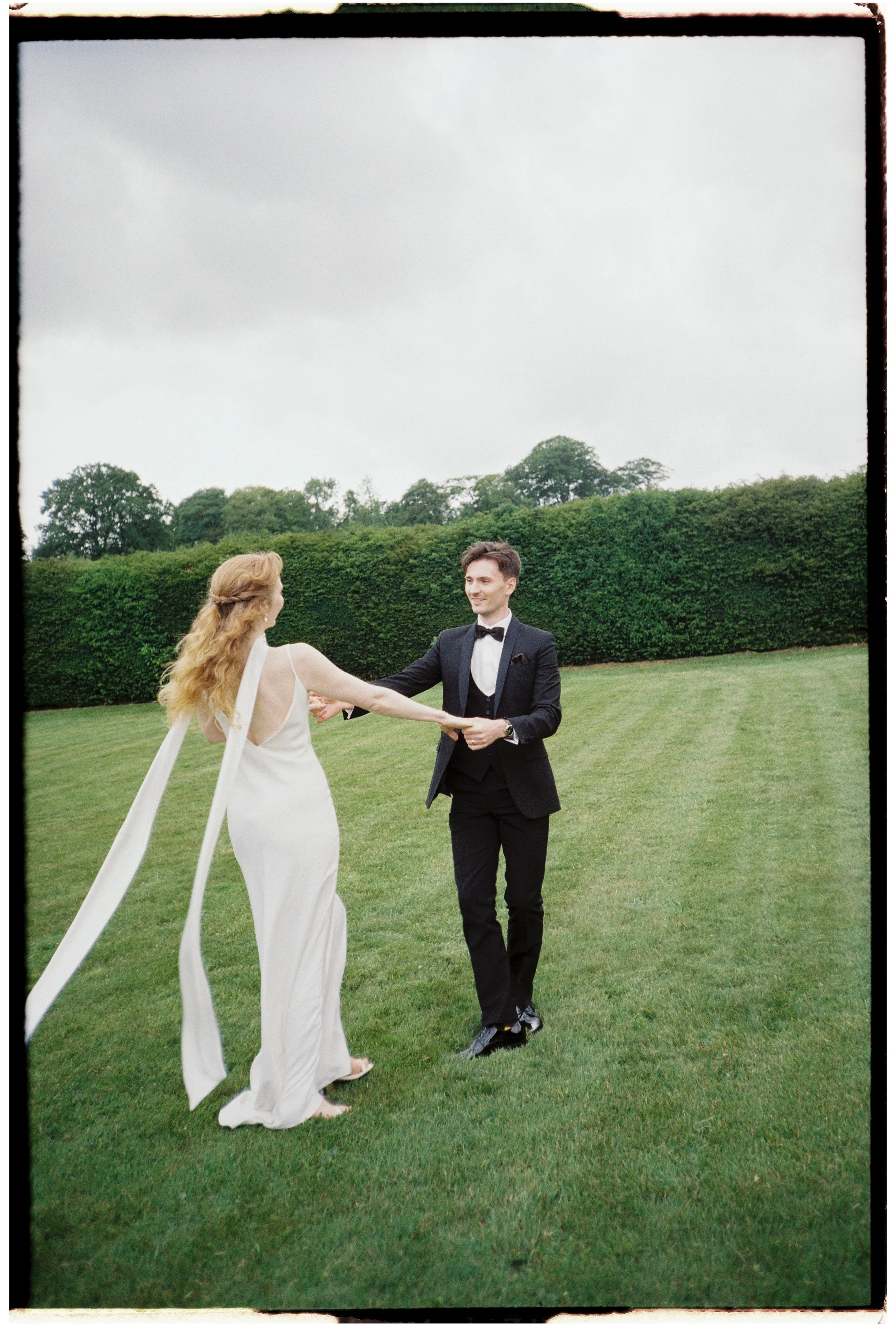  Unposed interaction between couple photographed on 35mm film with nostalgic texture 