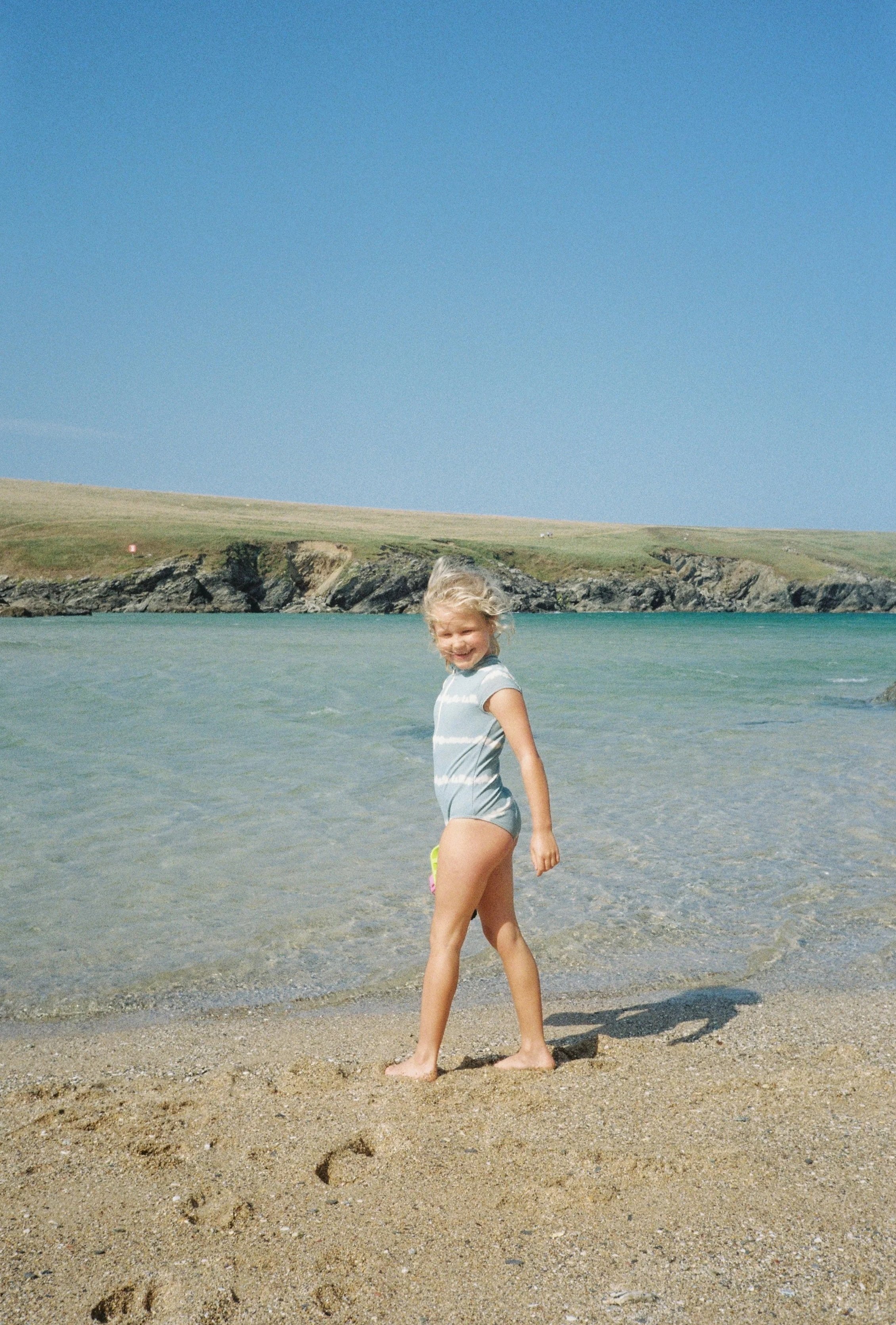 Natural childs portrait on the beach in cornwall that feels honest, warm, and unposed