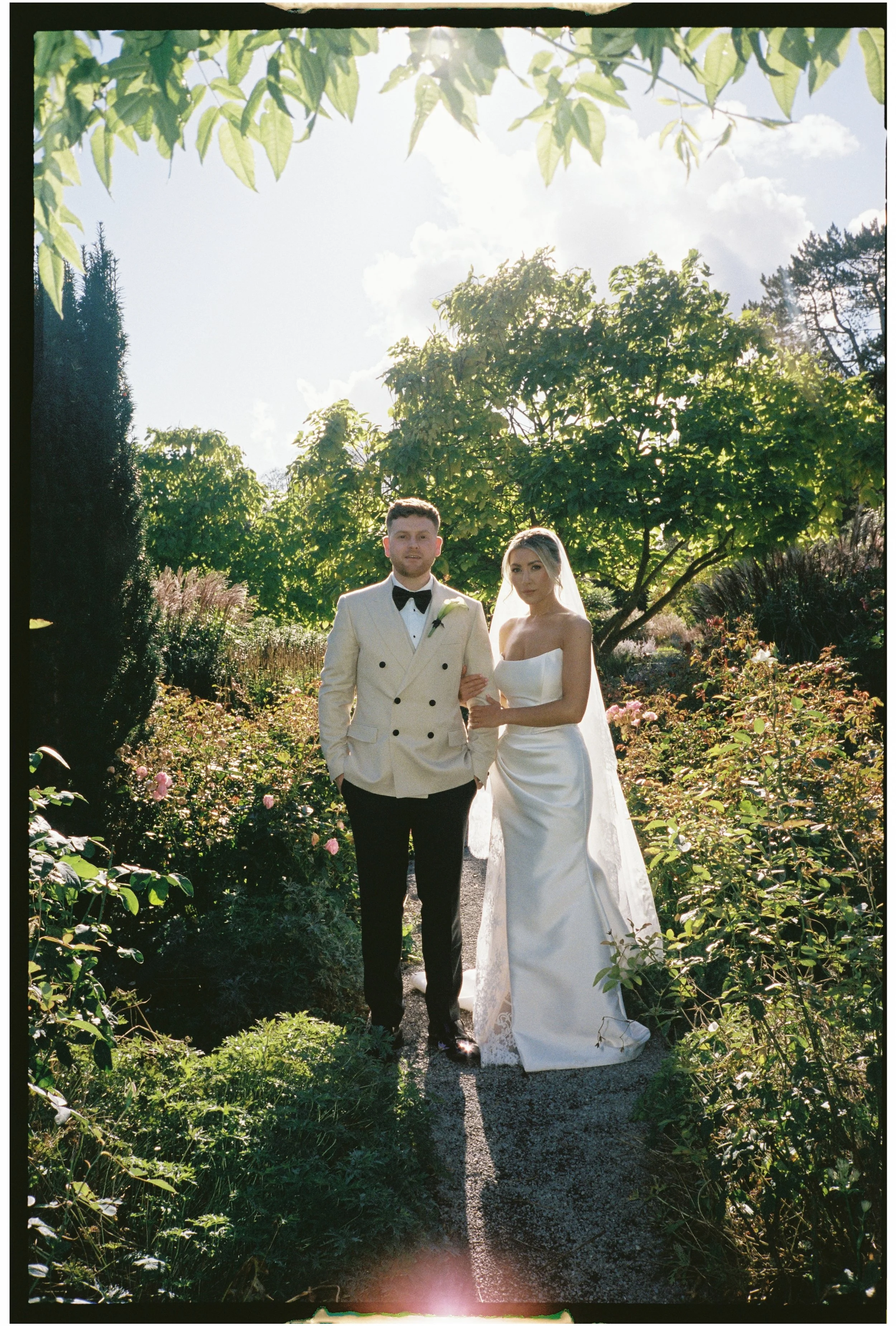 Editorial style wedding portrait captured on 35mm film with subtle grain and muted tones at Middleton Lodge wedding venue
