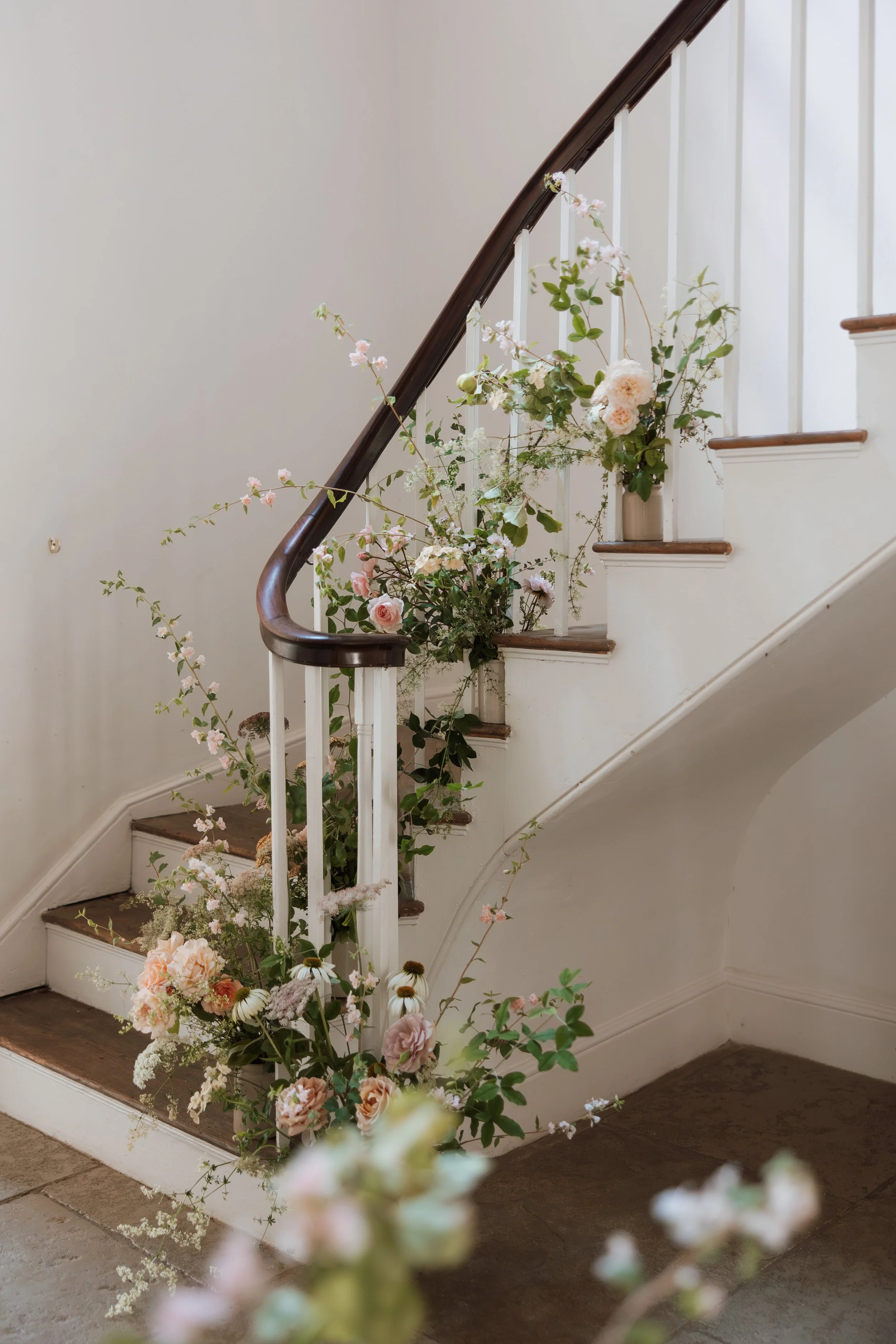 Floral wedding styling on staircase at Aswarby Rectory