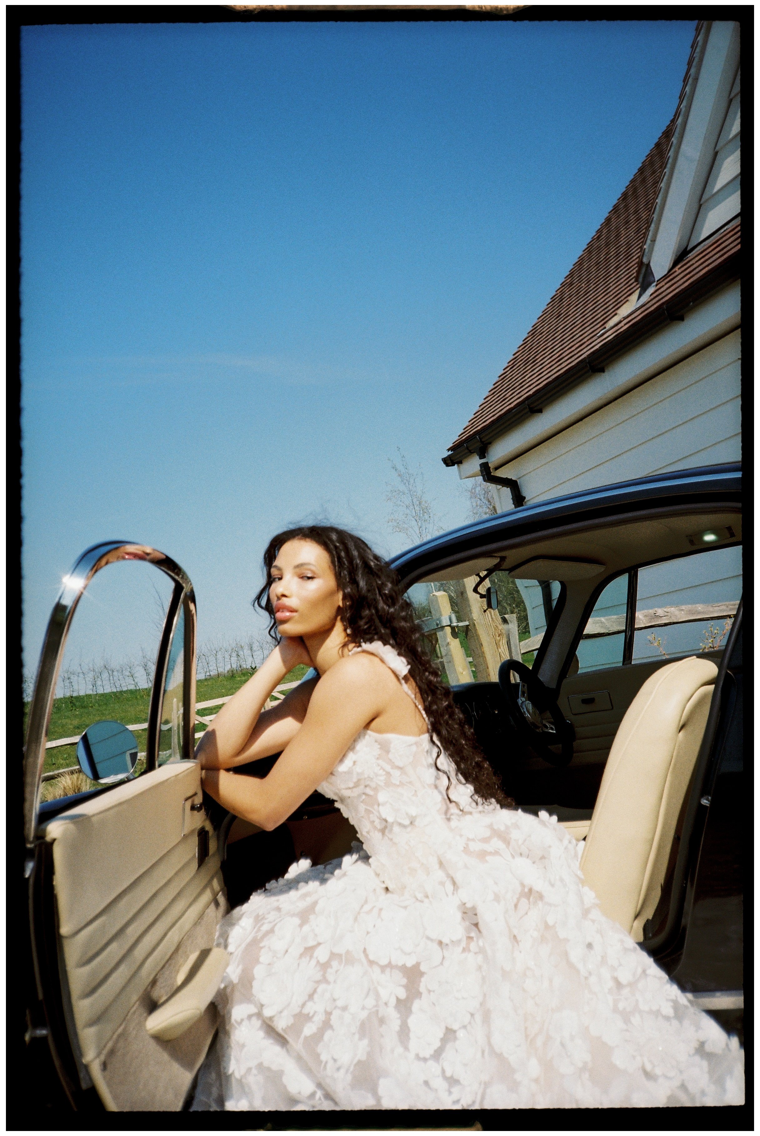 Editorial bridal moment in classic car at LIMEKILN wedding venue photographed on film with delicate grain and timeless feel