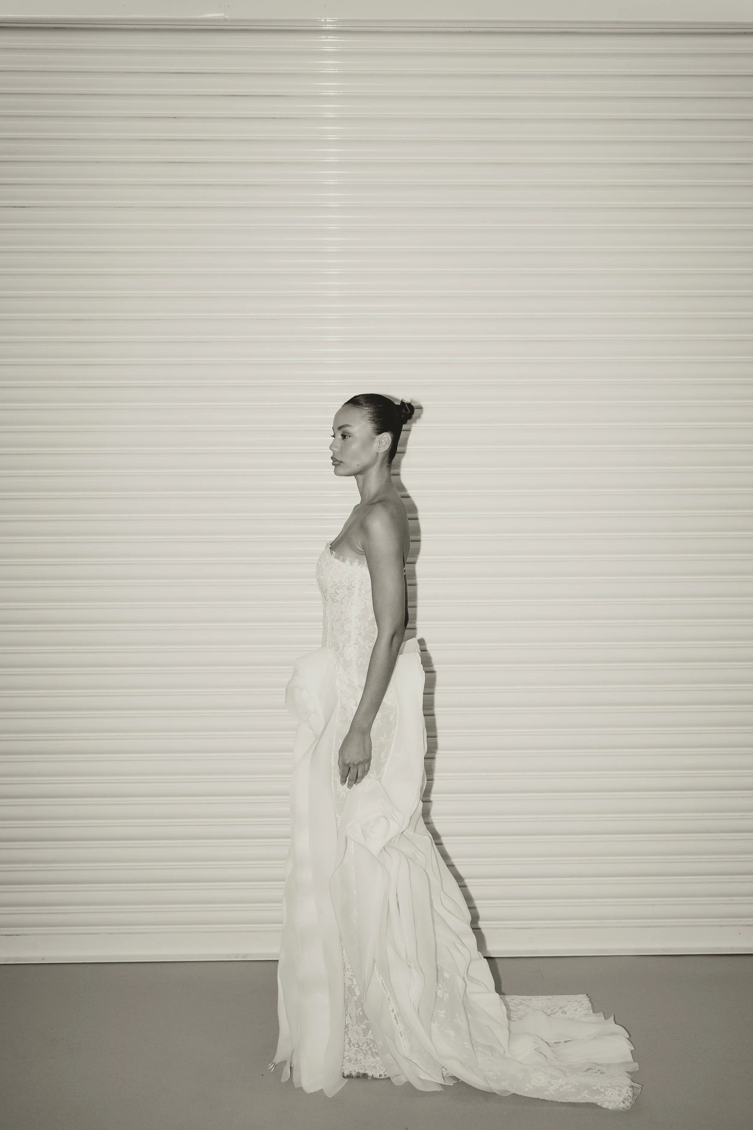 Editorial bridal fashion image at London Bridal Fashion Week 2026 featuring modern wedding dresses in soft, monochrome tones