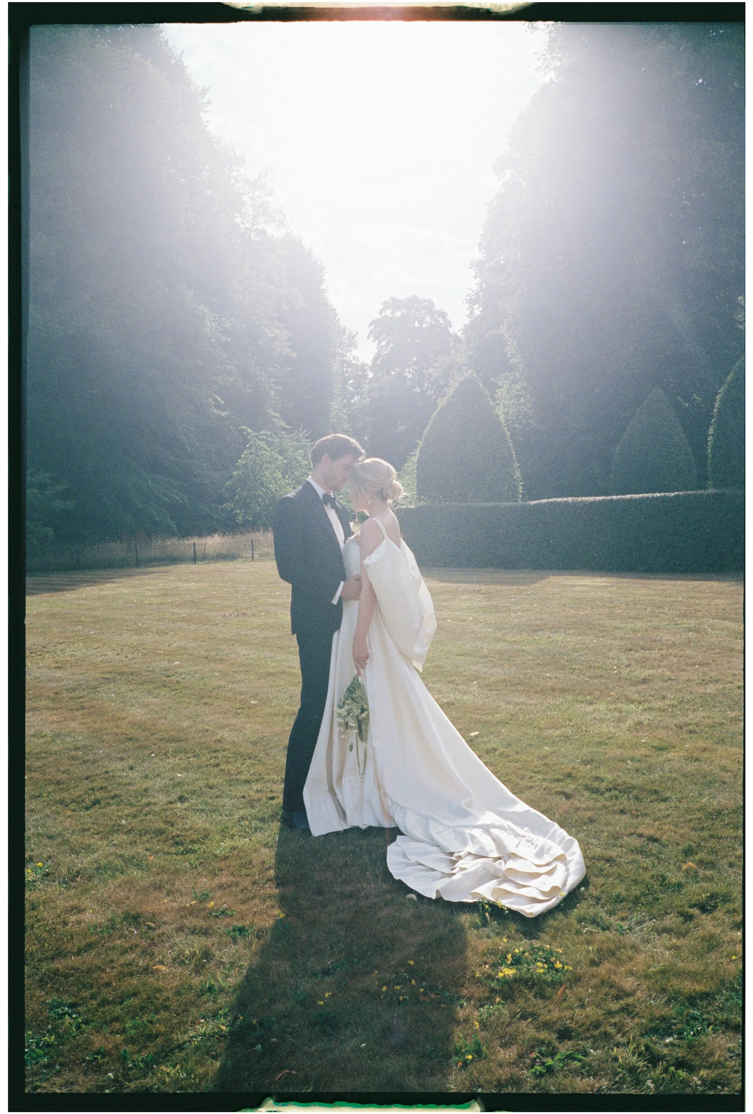 35mm film image. golden hour wedding photo with soft light and relaxed atmosphere at Norwood Park wedding venue.