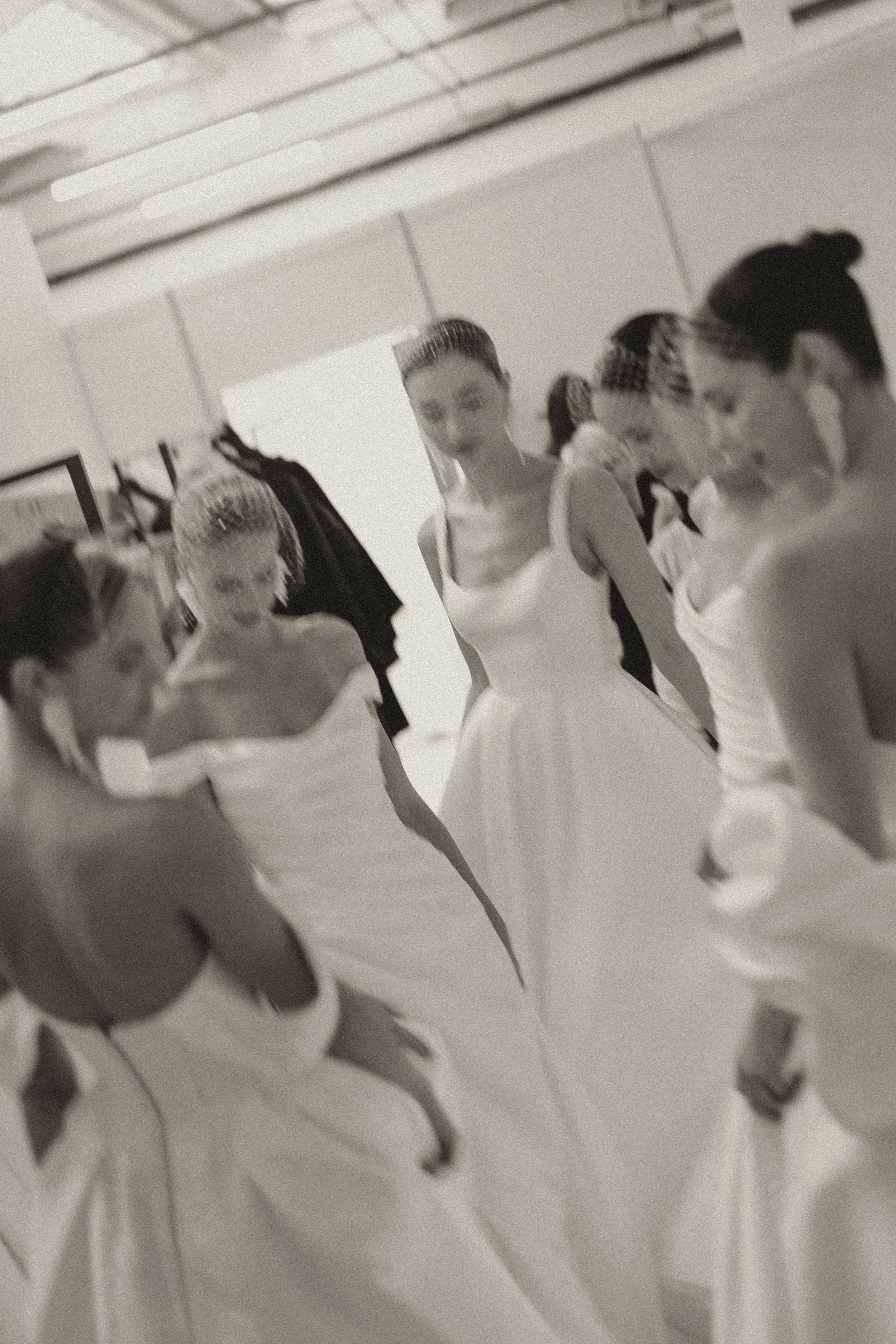 Candid backstage bridal fashion photography with movement and soft focus at London Bridal Fashion Week