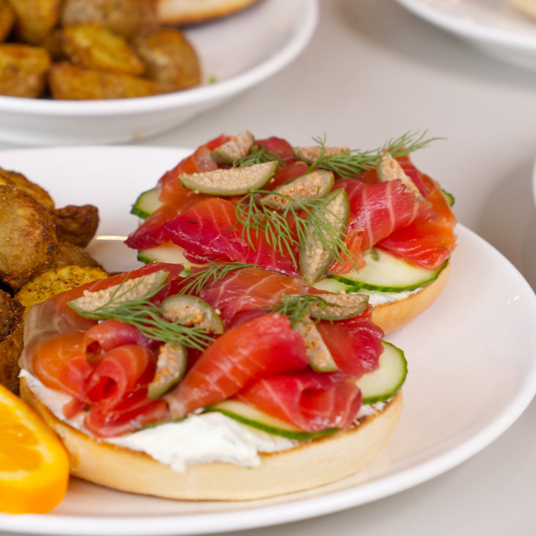 Beet cured salmon, dill cream cheese, cucumber, and caper berries on a toasted bagel, served with breakfast potatoes. best paired with iced matcha latte. 

Available all day!