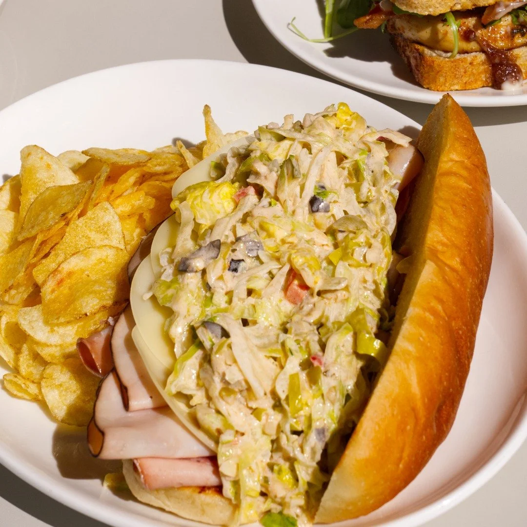 Ham, mortadella, genoa, iceberg lettuce, pepperoncini, and thousand island dressing.  our kitchen team did NOT have to go this hard on a deli sandwich, but here we are! (includes chips, pickles, and salad) best paired with iced chai latte or a cold b