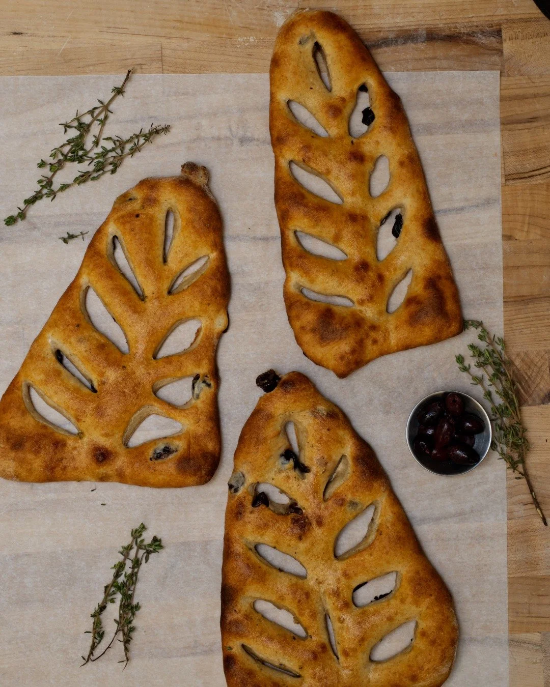Our baker is trying out something new! olives, thyme, and a crust you&rsquo;ll tear into before you get home ;)

Our fougasse is fresh out of the oven. Grab one for the table, or just eat it on the walk