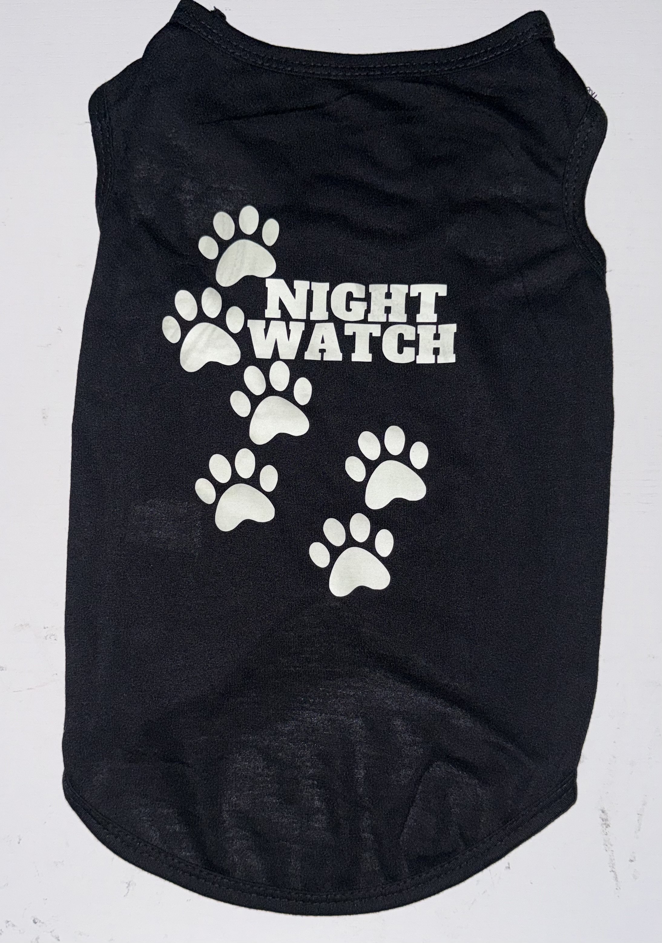 Lightweight polyester dog t-shirt featuring a glowing nighttime paw print design.