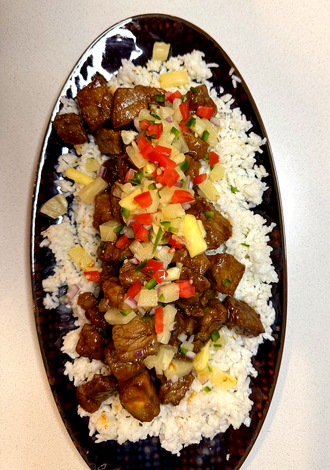 Aloha Steak bowl with rice, sauteed steak, and fresh pineapple relish