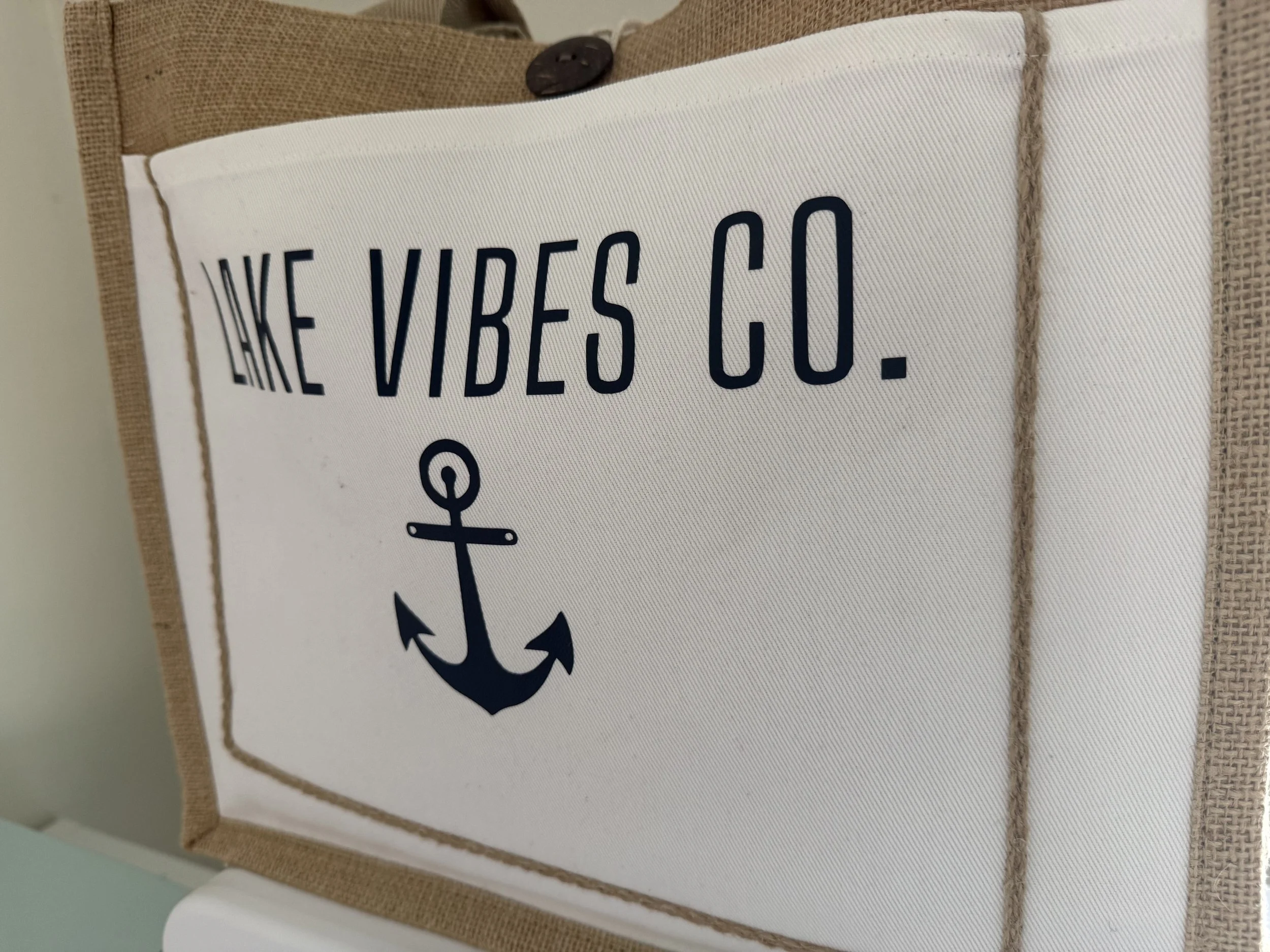 Natural woven jute tote bag collection featuring coastal and resort-inspired designs, perfect for lake life, beach vacations, boating, shopping, and travel.