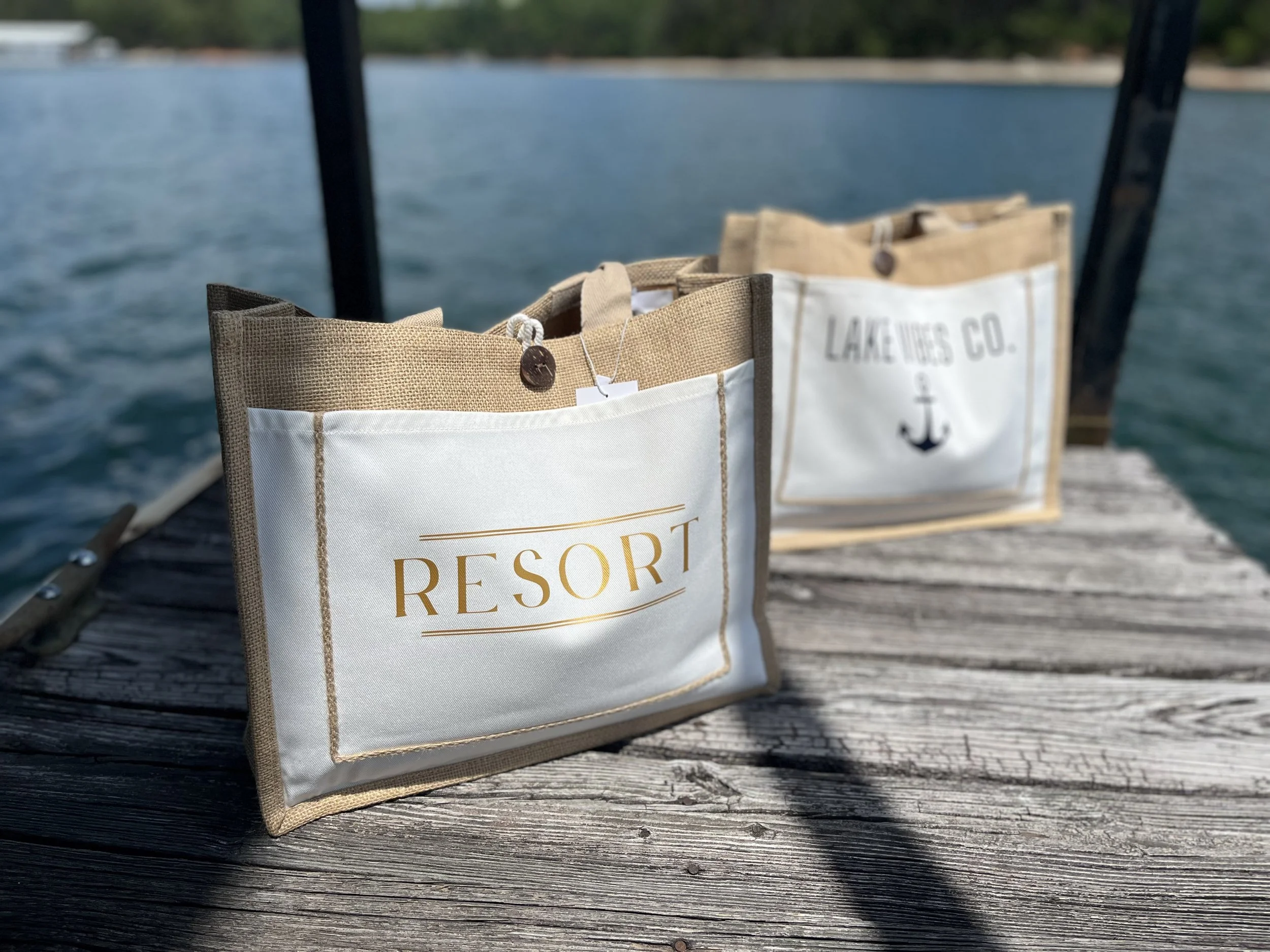 Natural woven jute tote bag collection featuring coastal and resort-inspired designs, perfect for lake life, beach vacations, boating, shopping, and travel.