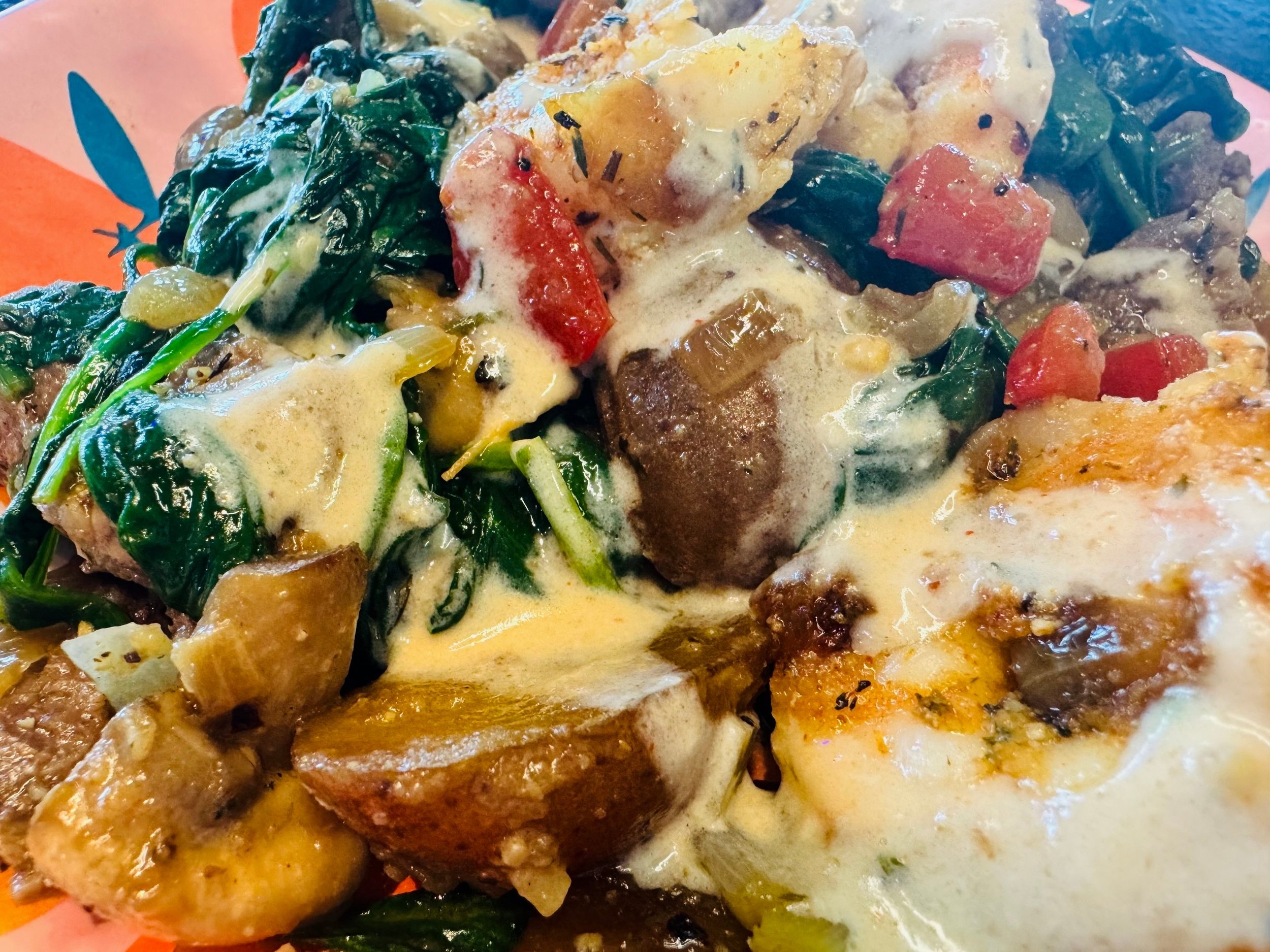 Juicy steak slices, succulent shrimp, crispy golden potatoes, sweet red peppers, and tender onions all come together in one sizzling skillet.