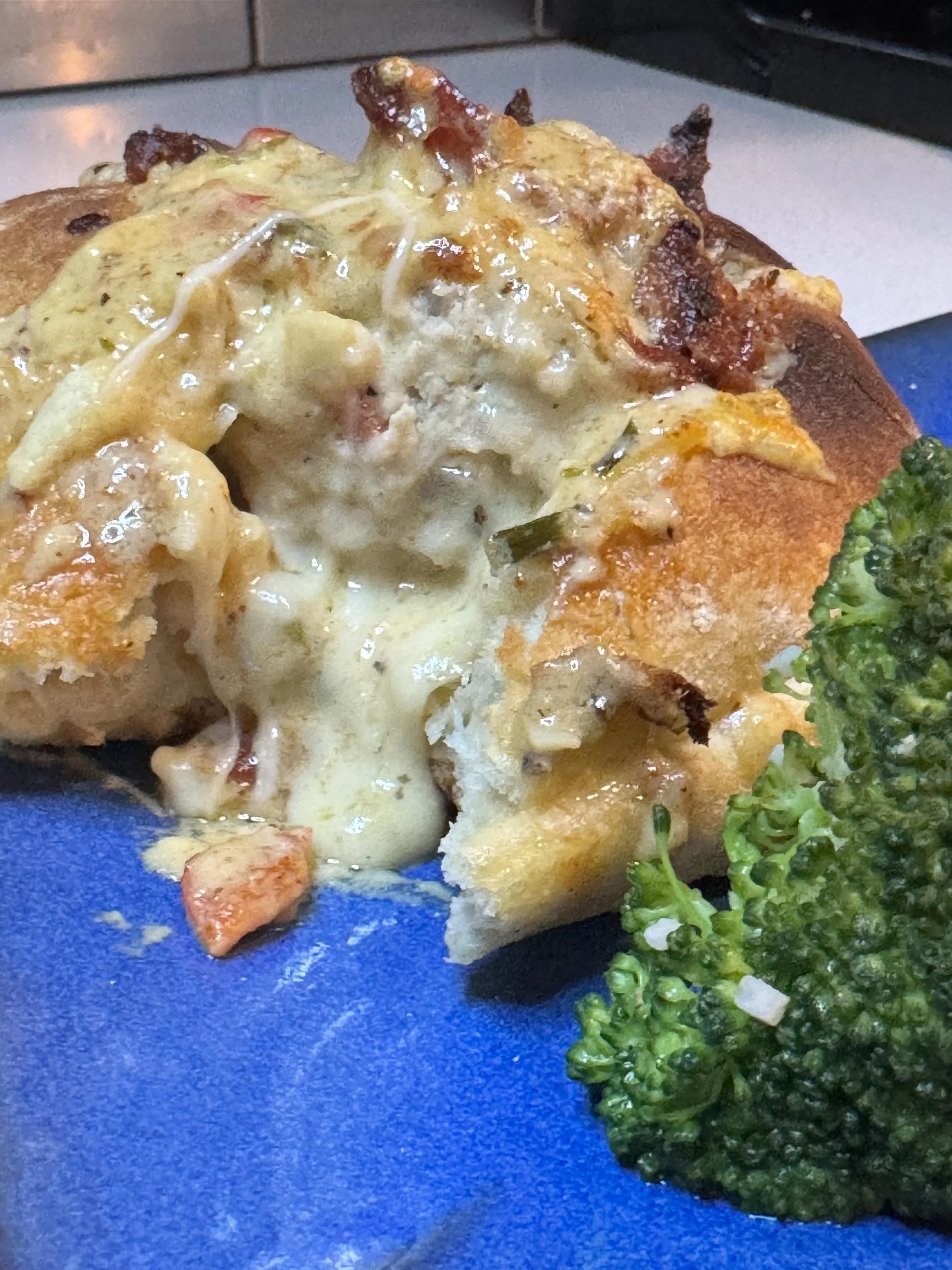 Cheesy chicken ciabatta bake topped with crispy bacon and creamy sauce
