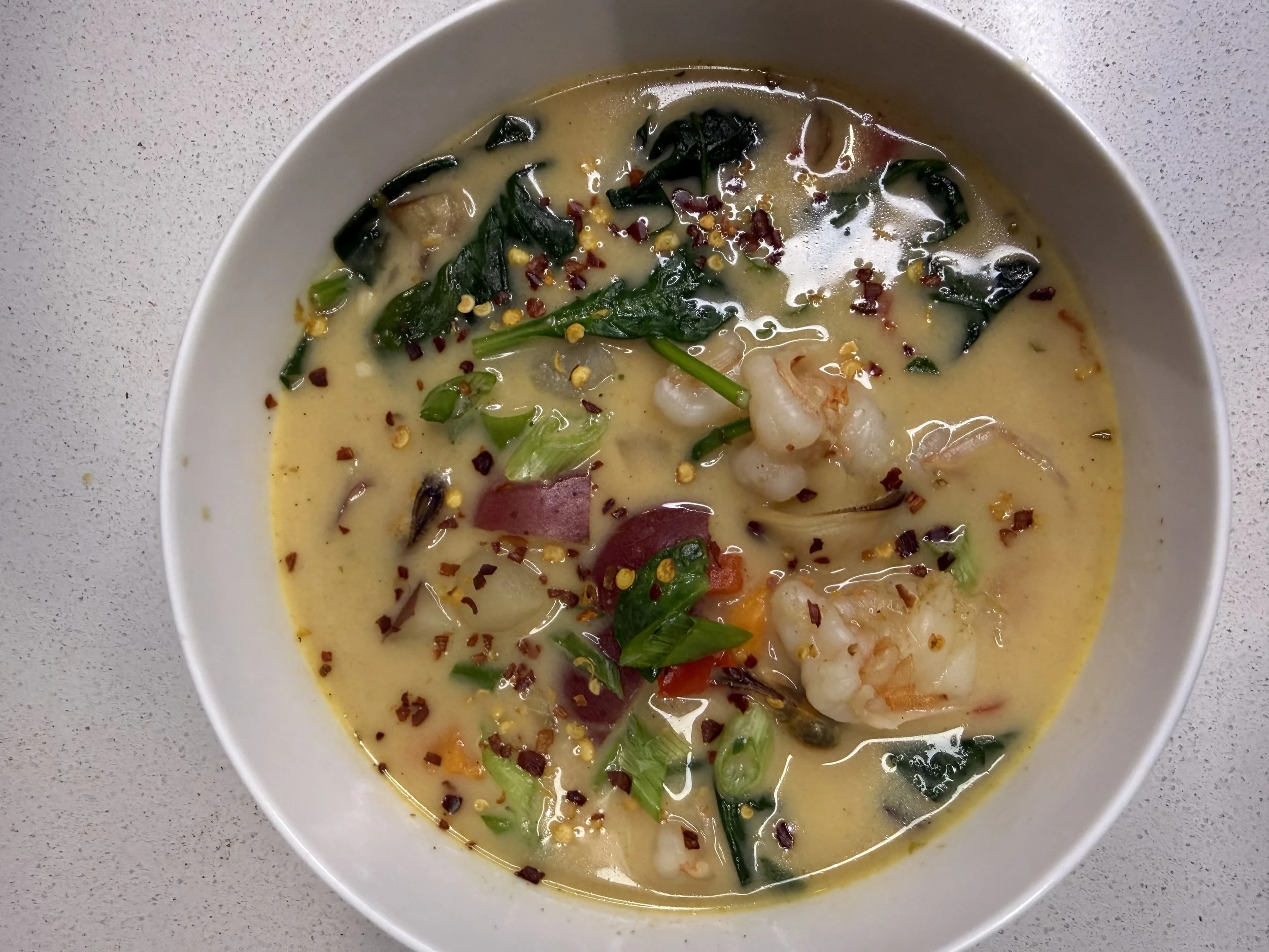 Creamy Cajun Seafood soup with veggies, shrimp, mussels and scallops