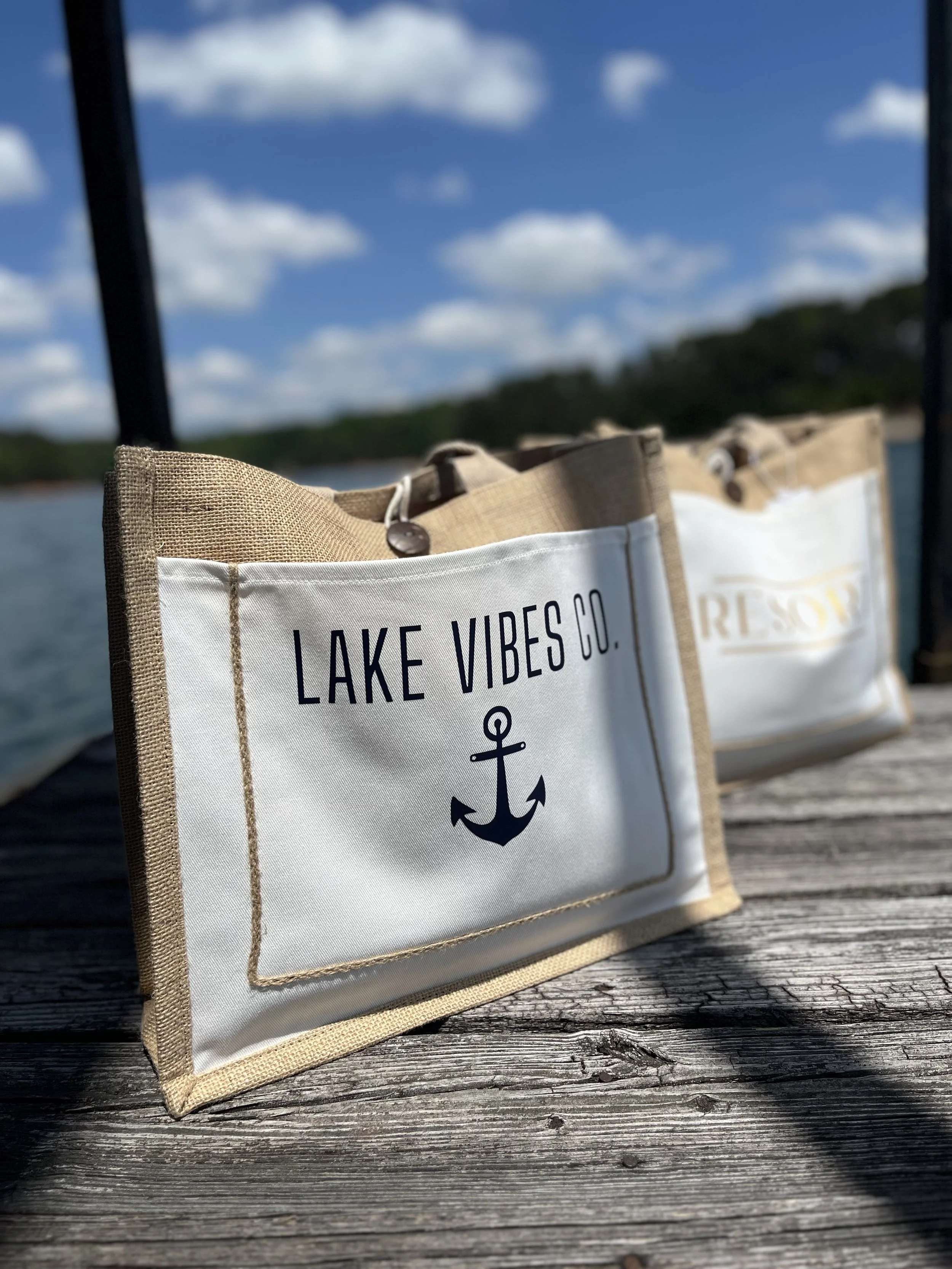 Natural woven jute tote bag collection featuring coastal and resort-inspired designs, perfect for lake life, beach vacations, boating, shopping, and travel.