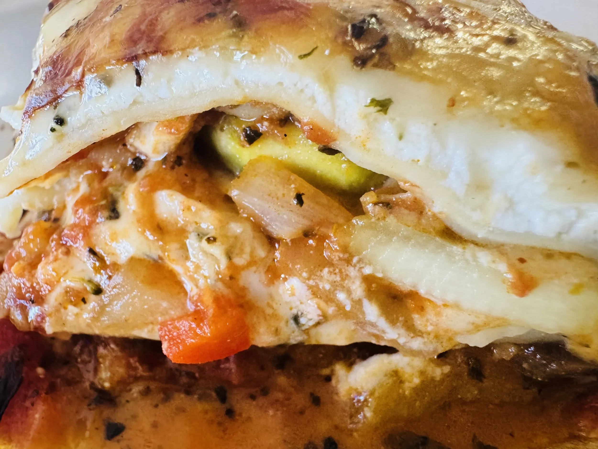 Cheesy veggie lasagna layered with roasted vegetables and rich tomato sauce