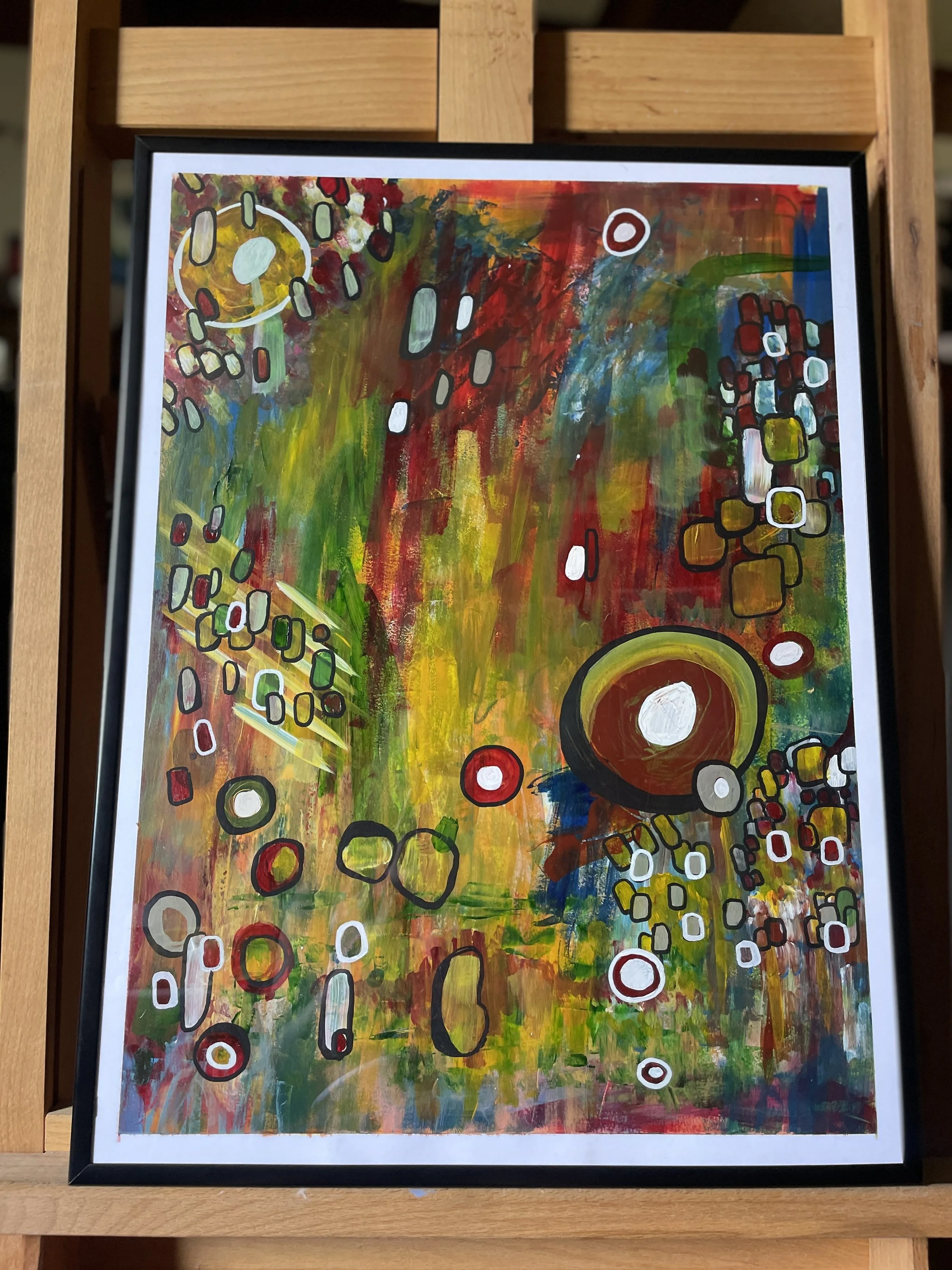 Photo of an original abstract painting by Shay Holloway. The painting sits in a frame on an easel in her studio in Northwest Arkansas.