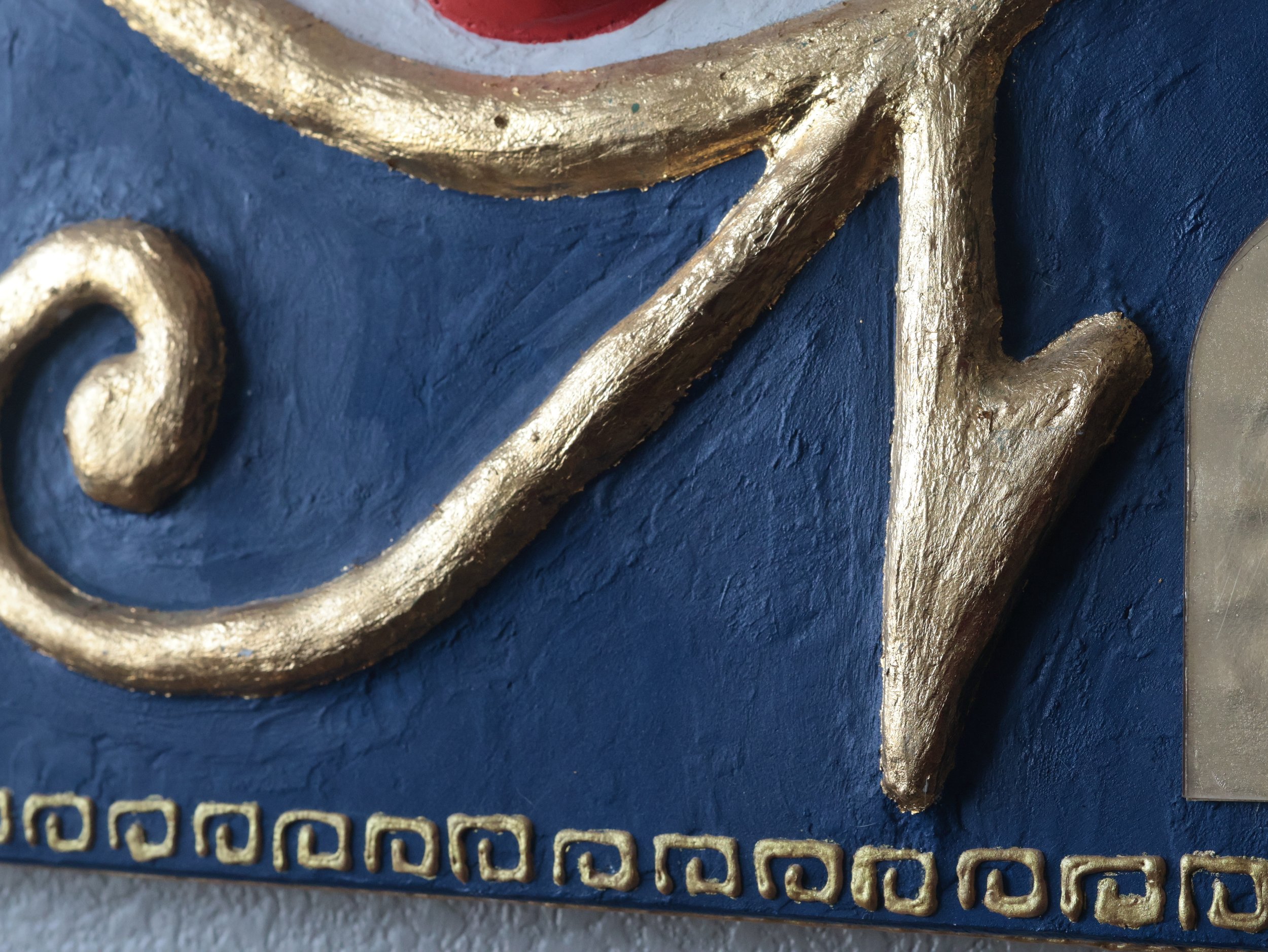 Up close, detailed photo of the border and lower portion of an Eye of Ra Egyptian art inspired painting.