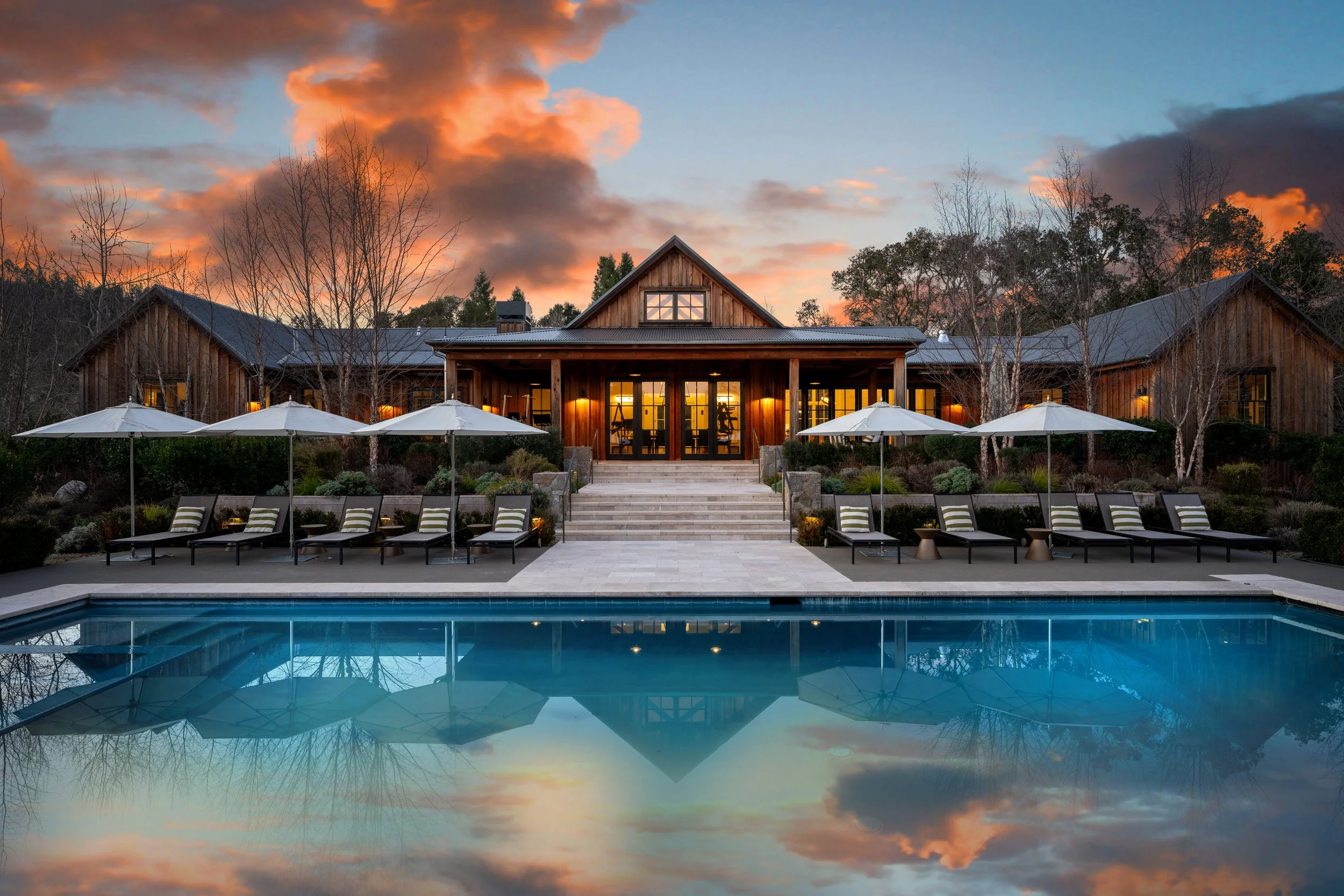 Resort-style rental with pool at sunset