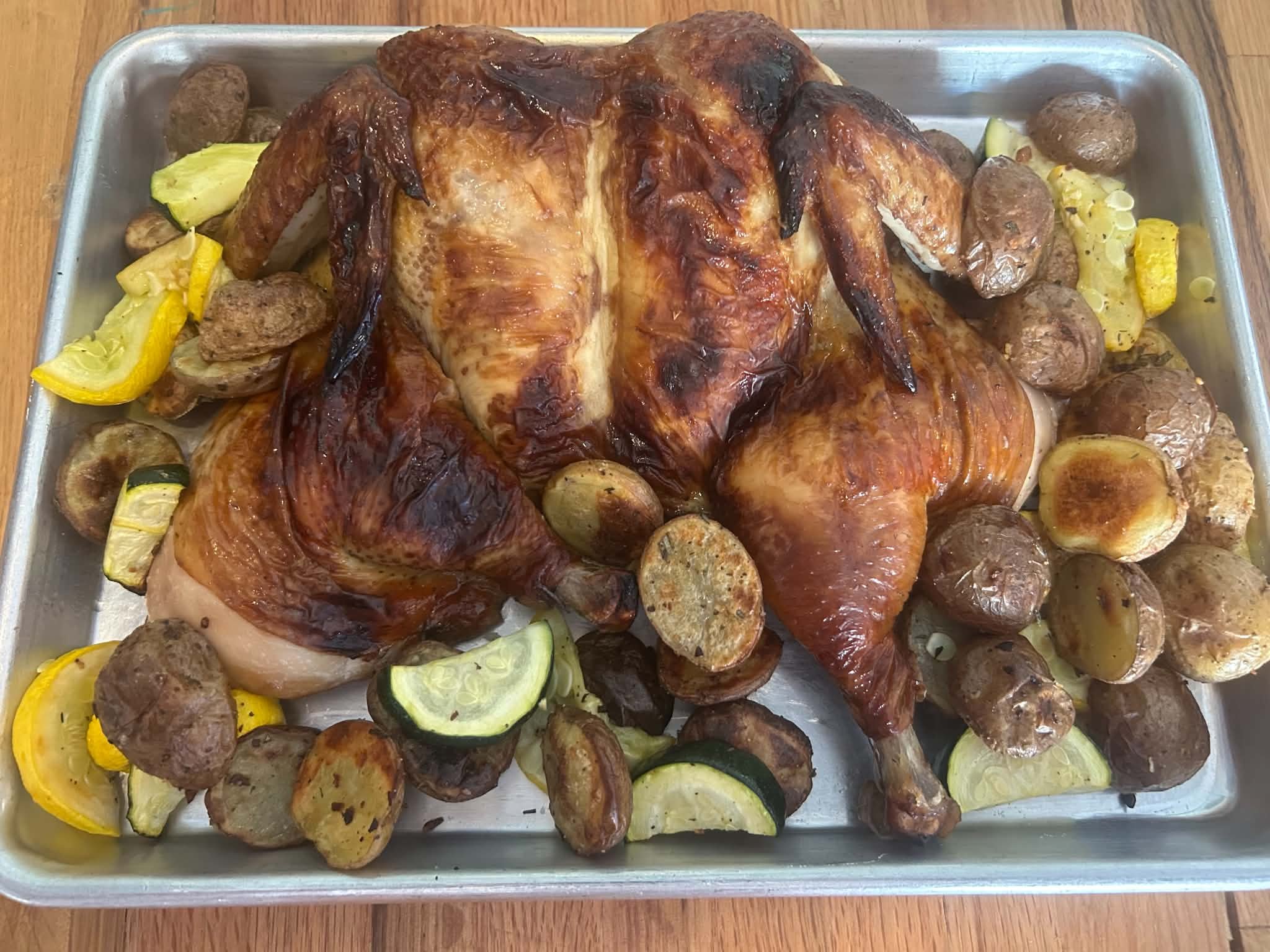 Brined Chicken Tray Bake: Sweet tea-brined, pasture-raised spatchcocked chicken from Buttonwood Farms with herb-roasted potatoes, zucchini and squash. An easy one-pan meal, ready in about an hour.
