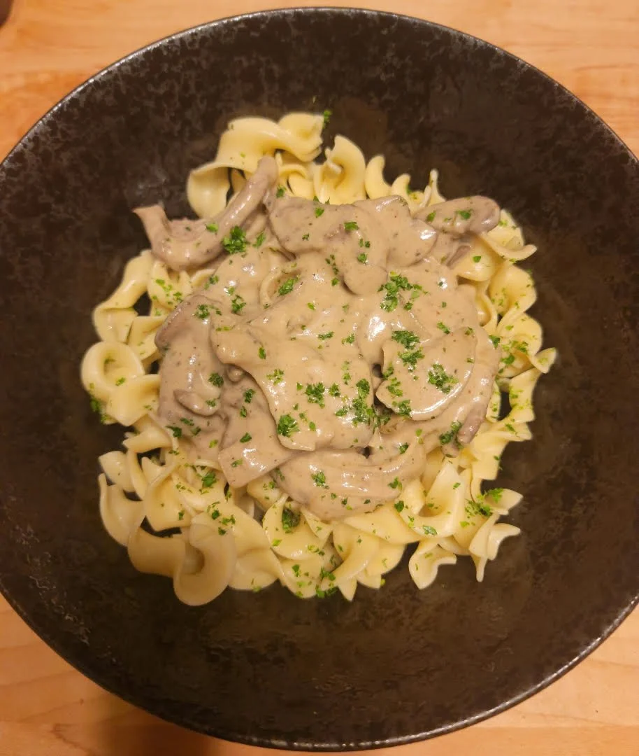 Beef Stroganoff: Tender marinated local beef with mushrooms and onions in a rich stroganoff sauce with stone-ground mustard and tarragon. Served over egg noodles and finished with mascarpone.
