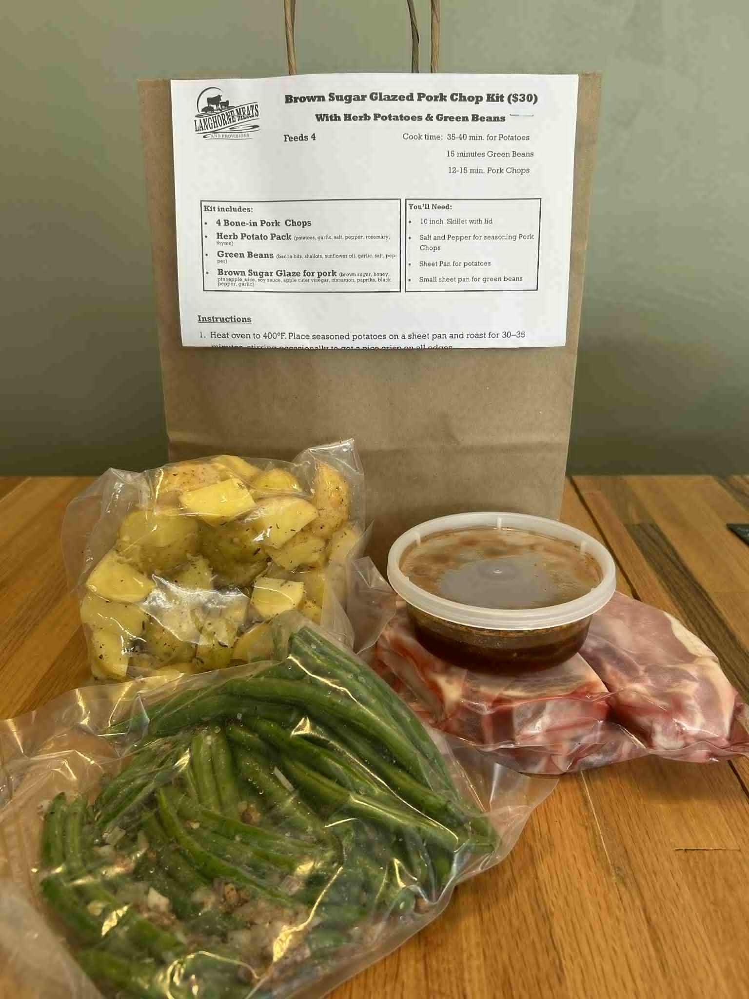 Brown Sugar Pork Chops: Heritage Berkshire bone-in pork chops from Idle Winds Farm with a sweet & tangy brown sugar glaze. Served with garlic & herb roasted potatoes and seasoned green beans. Ready in about 40 minutes.