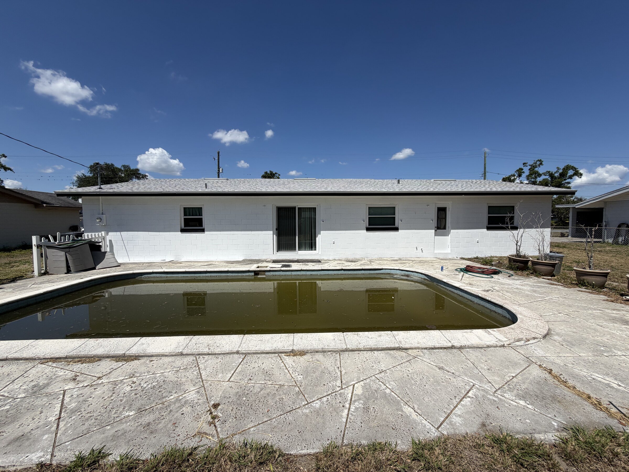 After: freshly repainted exterior and cleaned pool deck in Polk County, FL