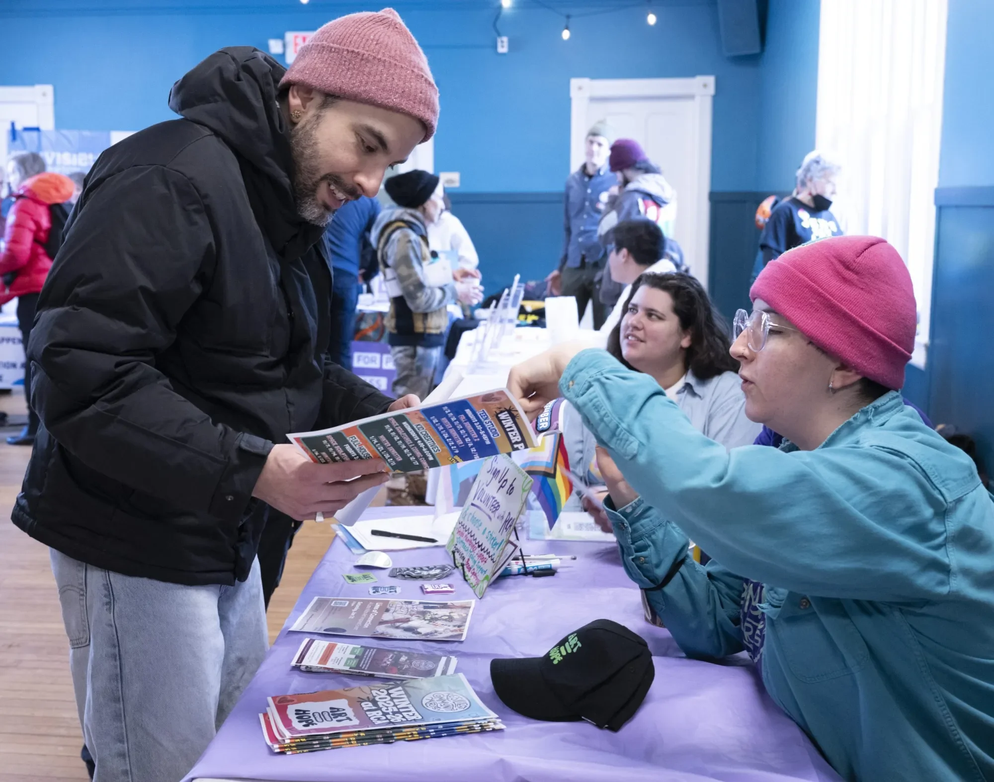 Andrew Turgeon talks with Maddie McDougall, the executive director with Resilient Community Arts of Easthampton at the MLK Jr. Day service fair organized by Florence Congregational Church , Bombyx Center for Arts and Equity and Beit Ahavah, Monday mo