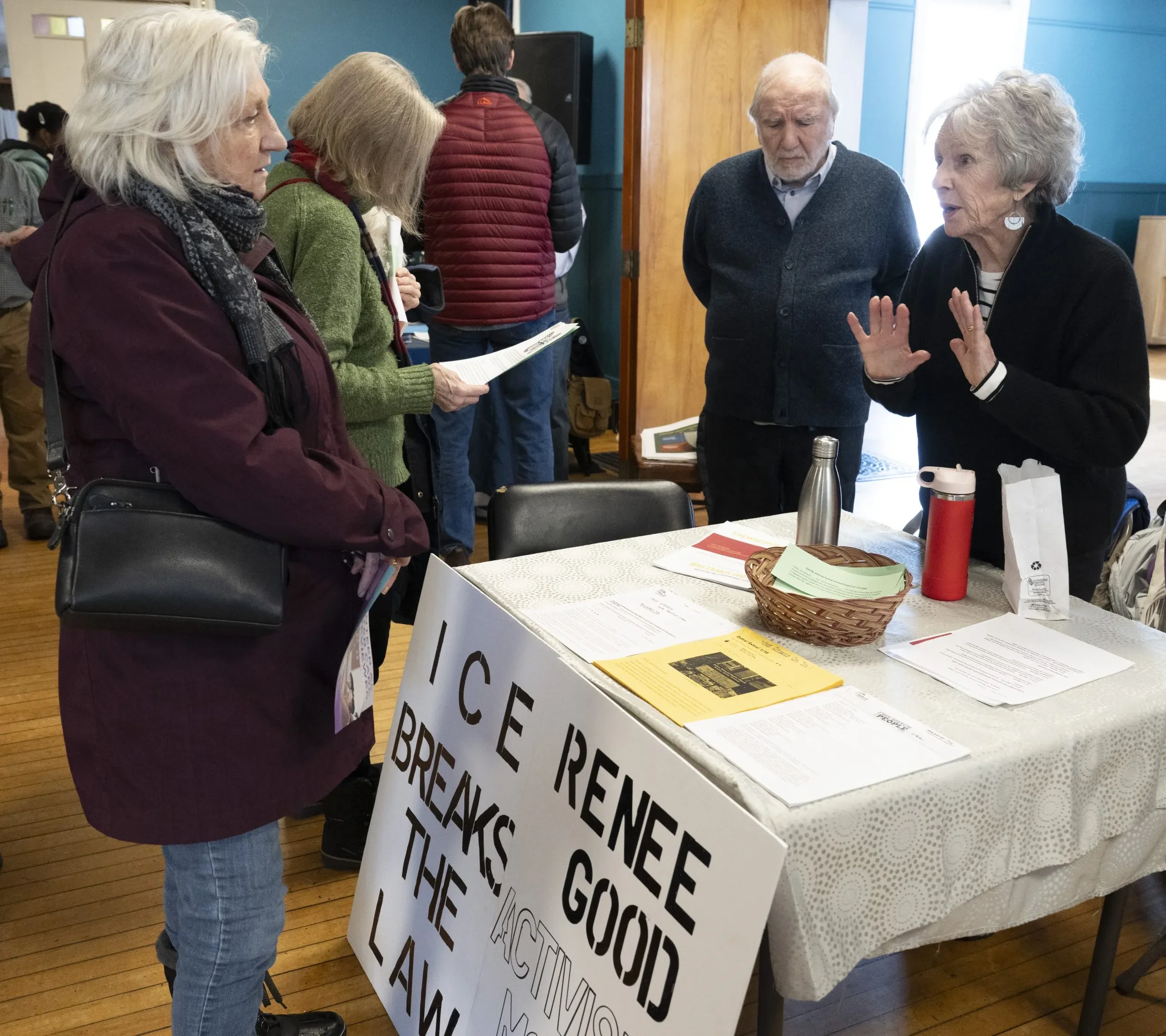 Amelia Wright, left, talks with Janet Nelson, a member of Swing Blue Alliance advocating for action against ICE, at the MLK Jr. Day service fair organized by Florence Congregational Church, Bombyx Center for Arts and Equity and Beit Ahavah, Monday mo