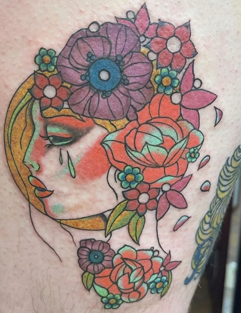 A full-color thigh tattoo depicting Dani from Midsommar.