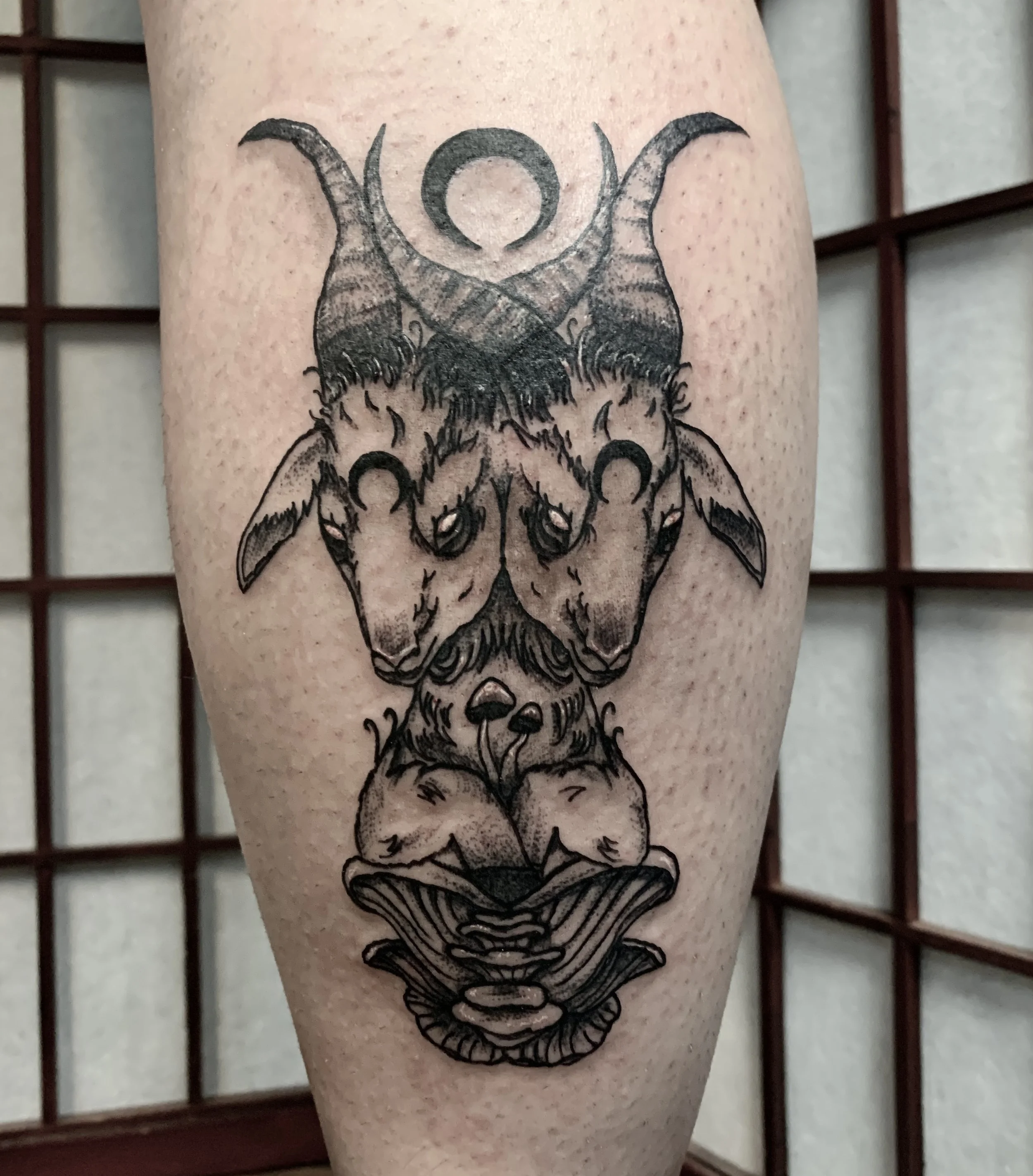 An occult two-headed ghost demon tattoo done in black and grey.