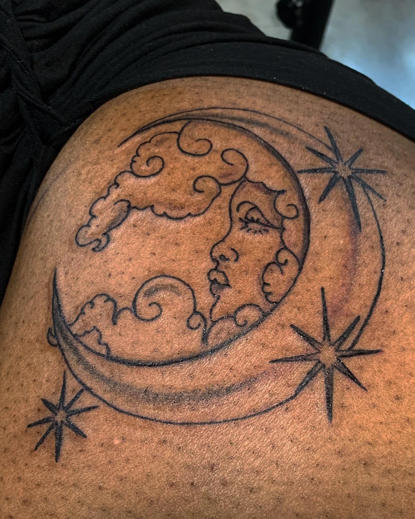 Moon face hip tattoo black and grey