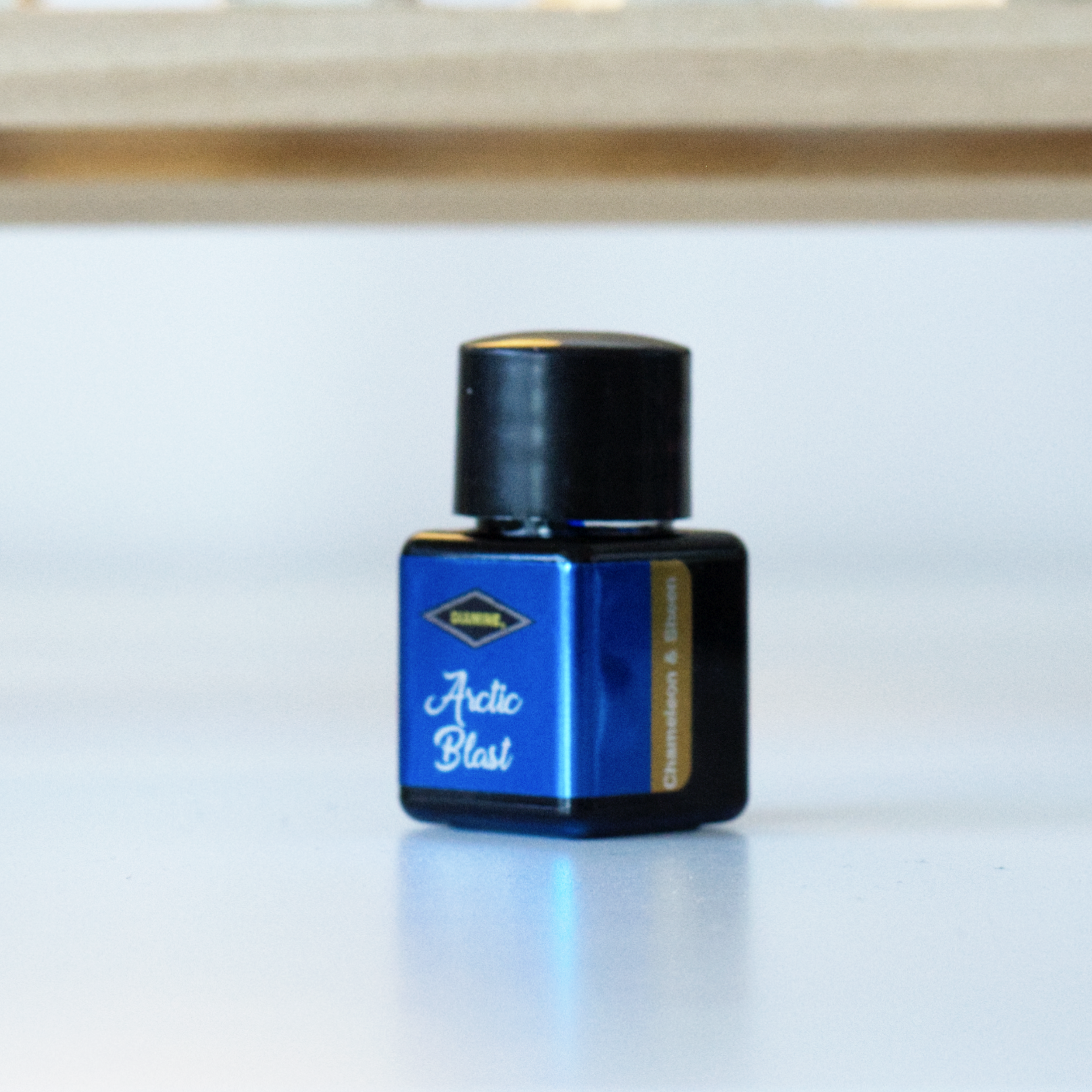 A photo of the 12mL bottle of Diamine fountain pen ink, in the colour Arctic Blast.