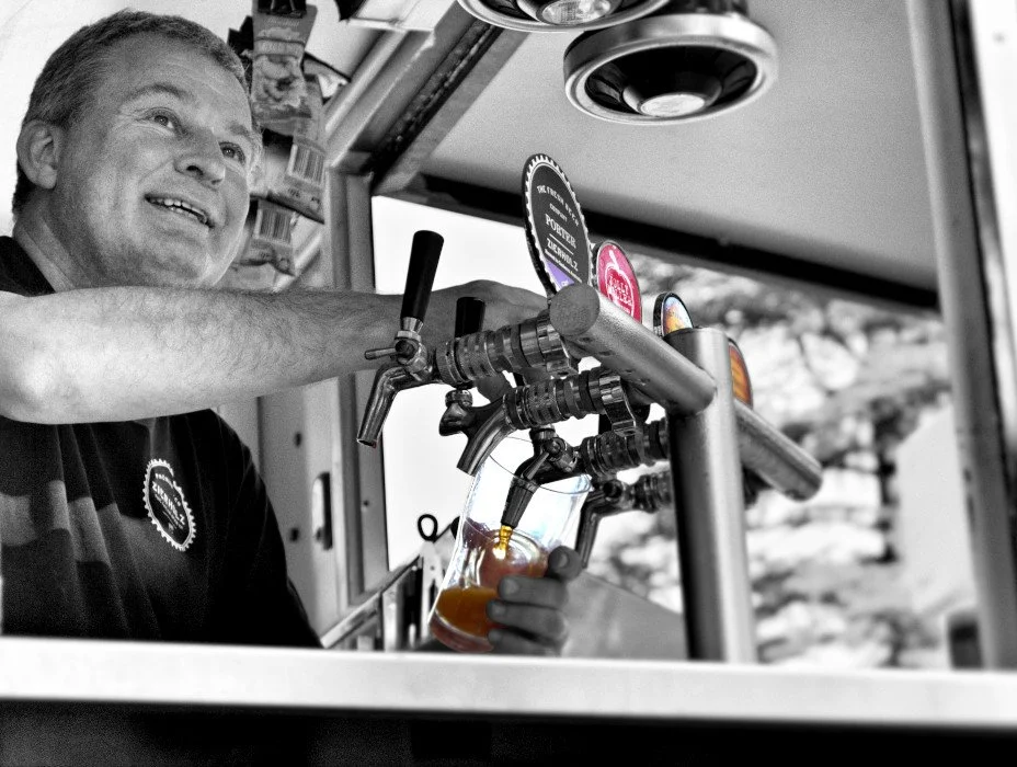 Christoph pouring beer at the pop-up bar