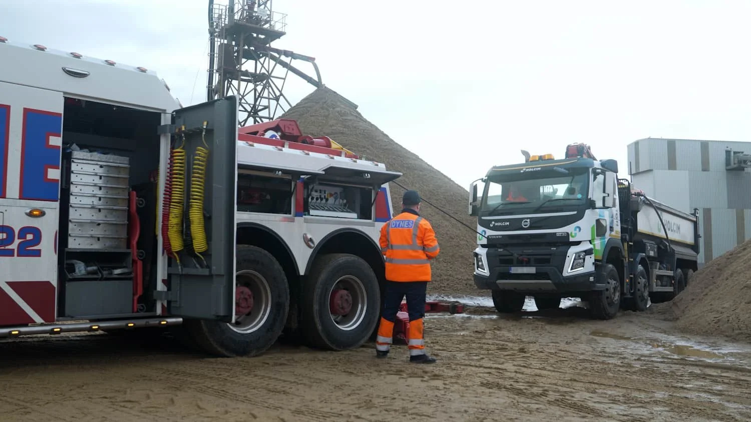 Dynes Motor Group heavy recovery truck winching a stranded HGV from sand at an aggregate site during a recovery operation