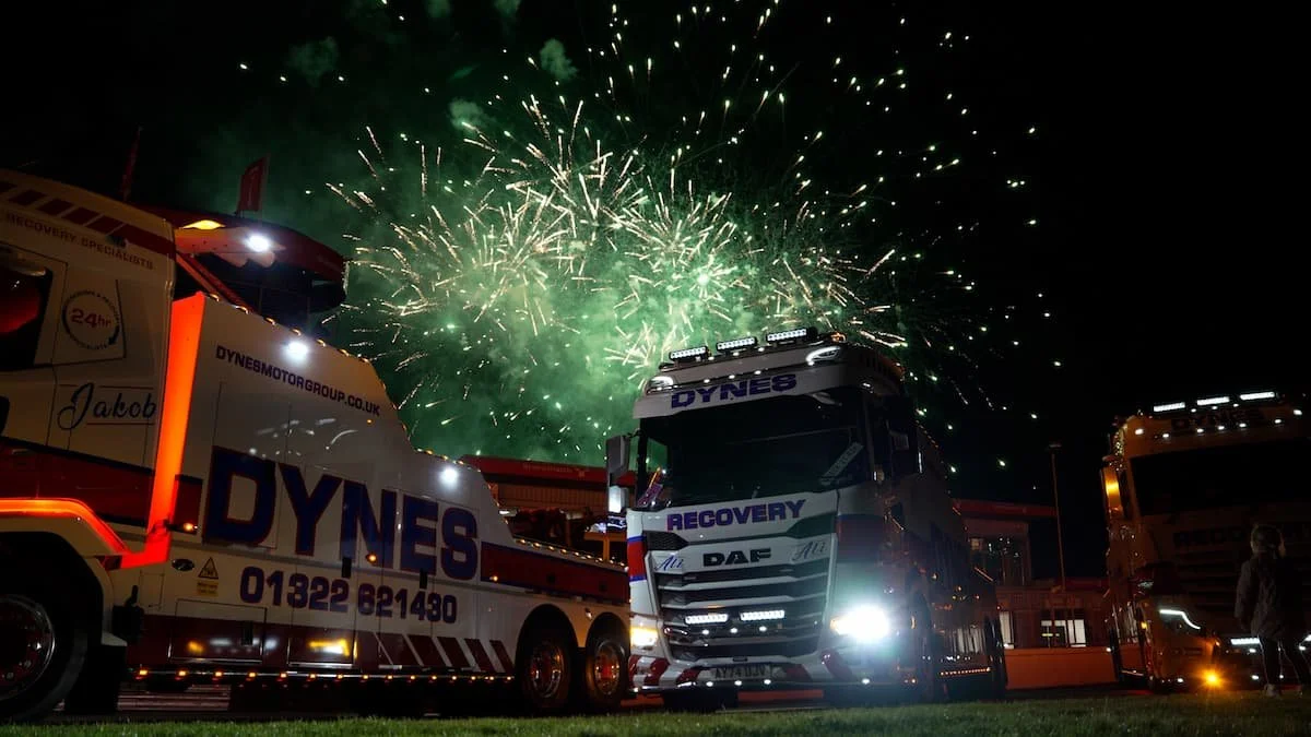 Dynes Motor Group branded recovery trucks at Brands Hatch during a fireworks event