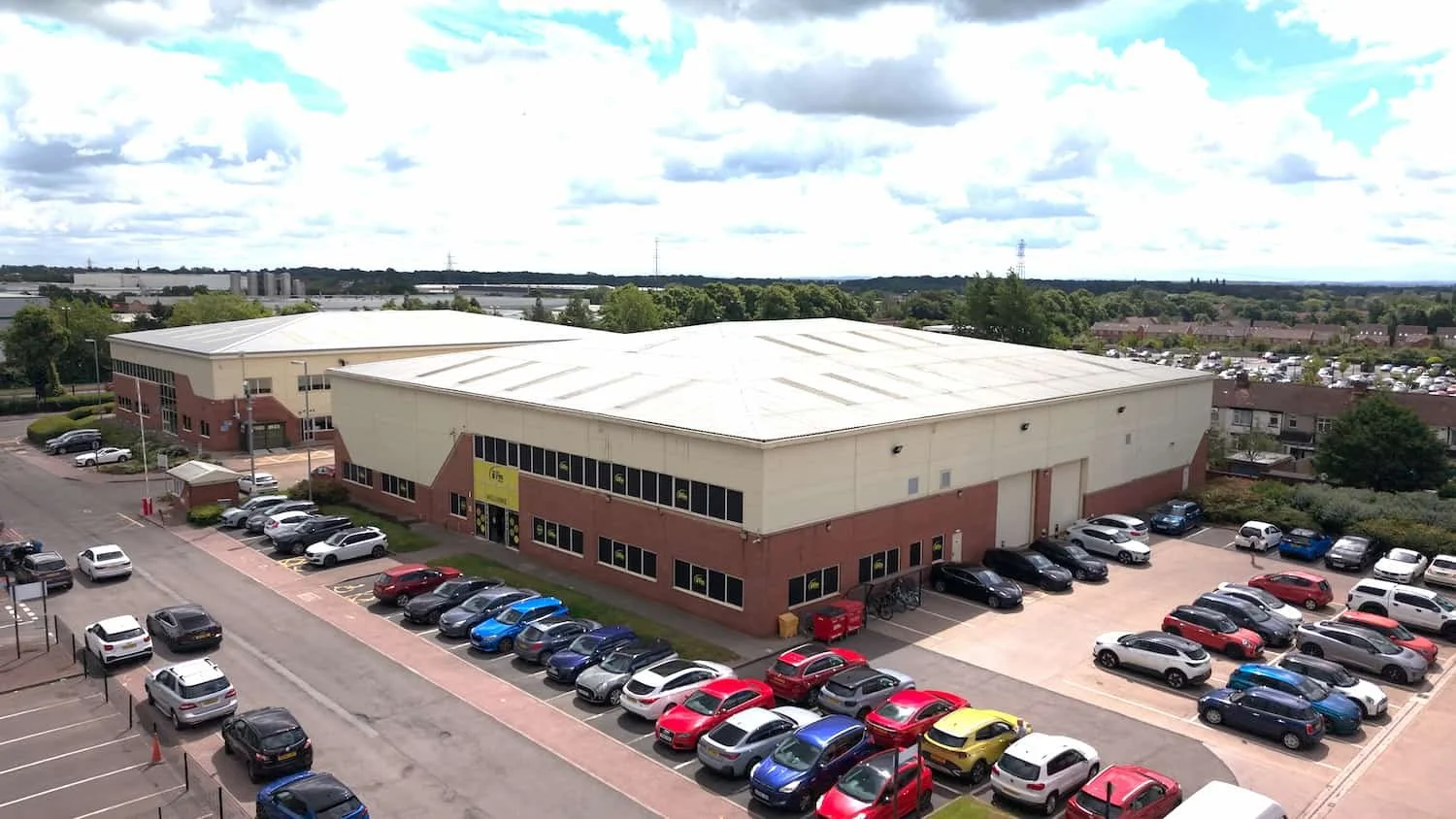 An aerial view of a Simply Gym in Coventry, surrounded by trees and open sky.