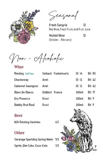 Menu featuring seasonal and non-alcoholic drinks, including fresh sangria, mulled wine, wines, beers, and soft drinks, with floral decorations and a sketch of a bear.