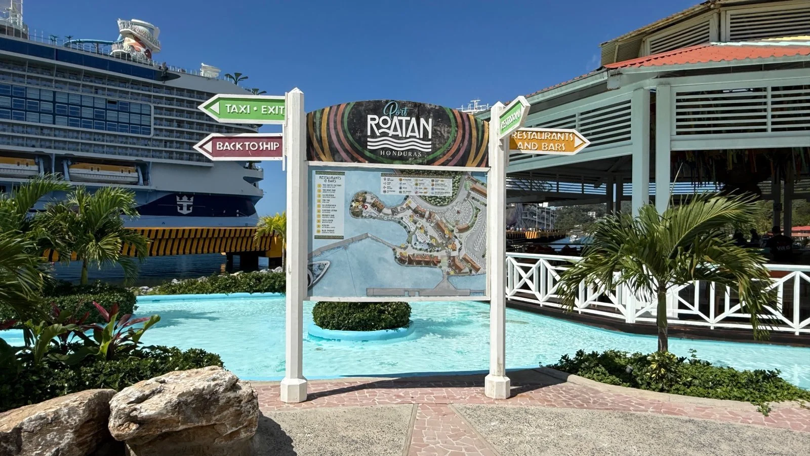 Port of Roatán sign and map with cruise ship docked nearby and Caribbean port facilities in Honduras