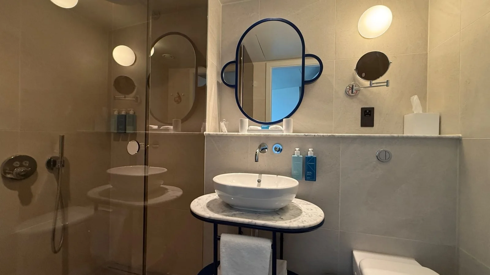 Modern bathroom at art’otel London Battersea Power Station featuring contemporary fittings, walk-in shower and KEVIN.MURPHY amenities.