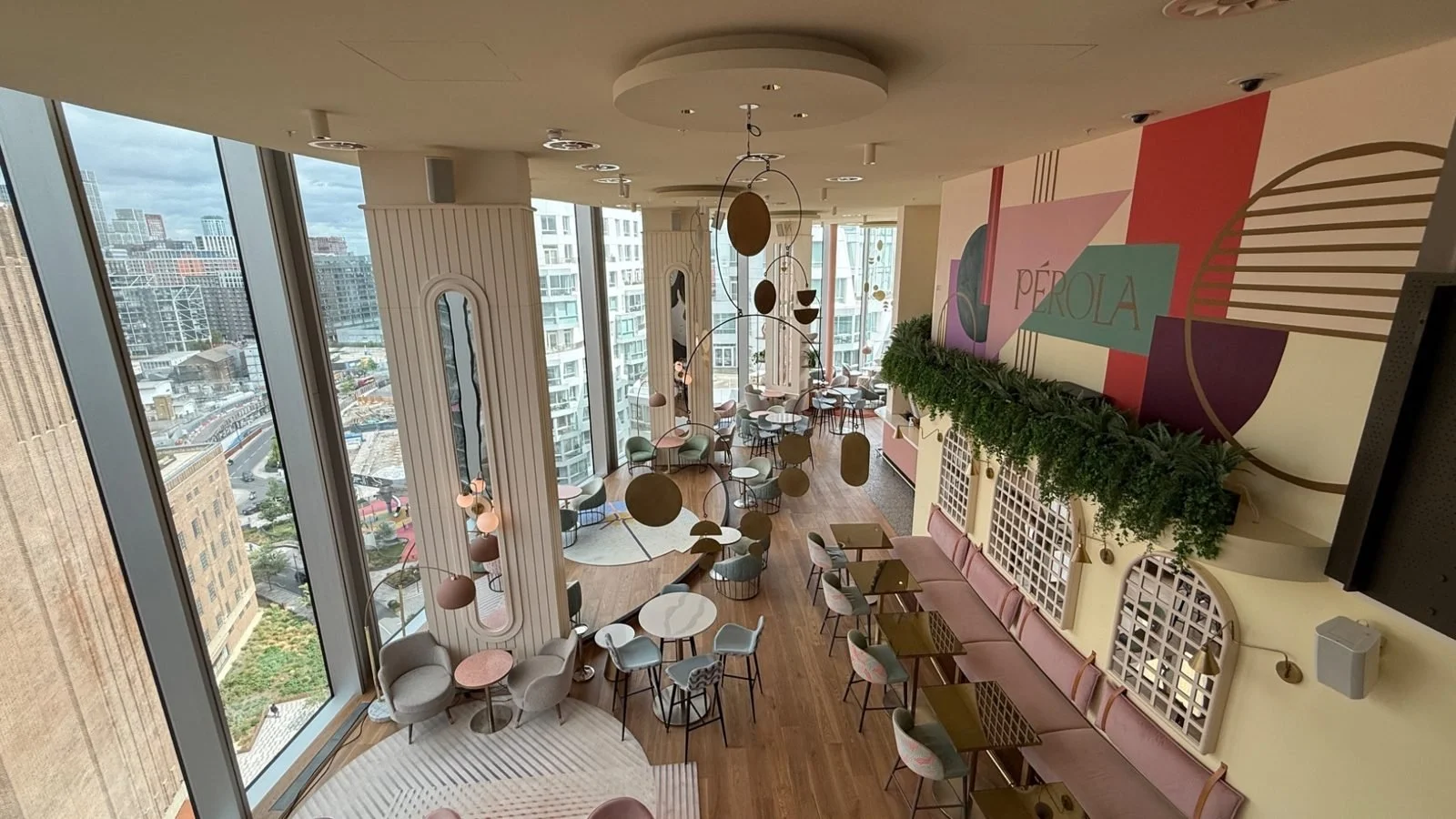 Interior of Pérgola rooftop bar at art’otel London Battersea Power Station with pastel décor and panoramic city views
