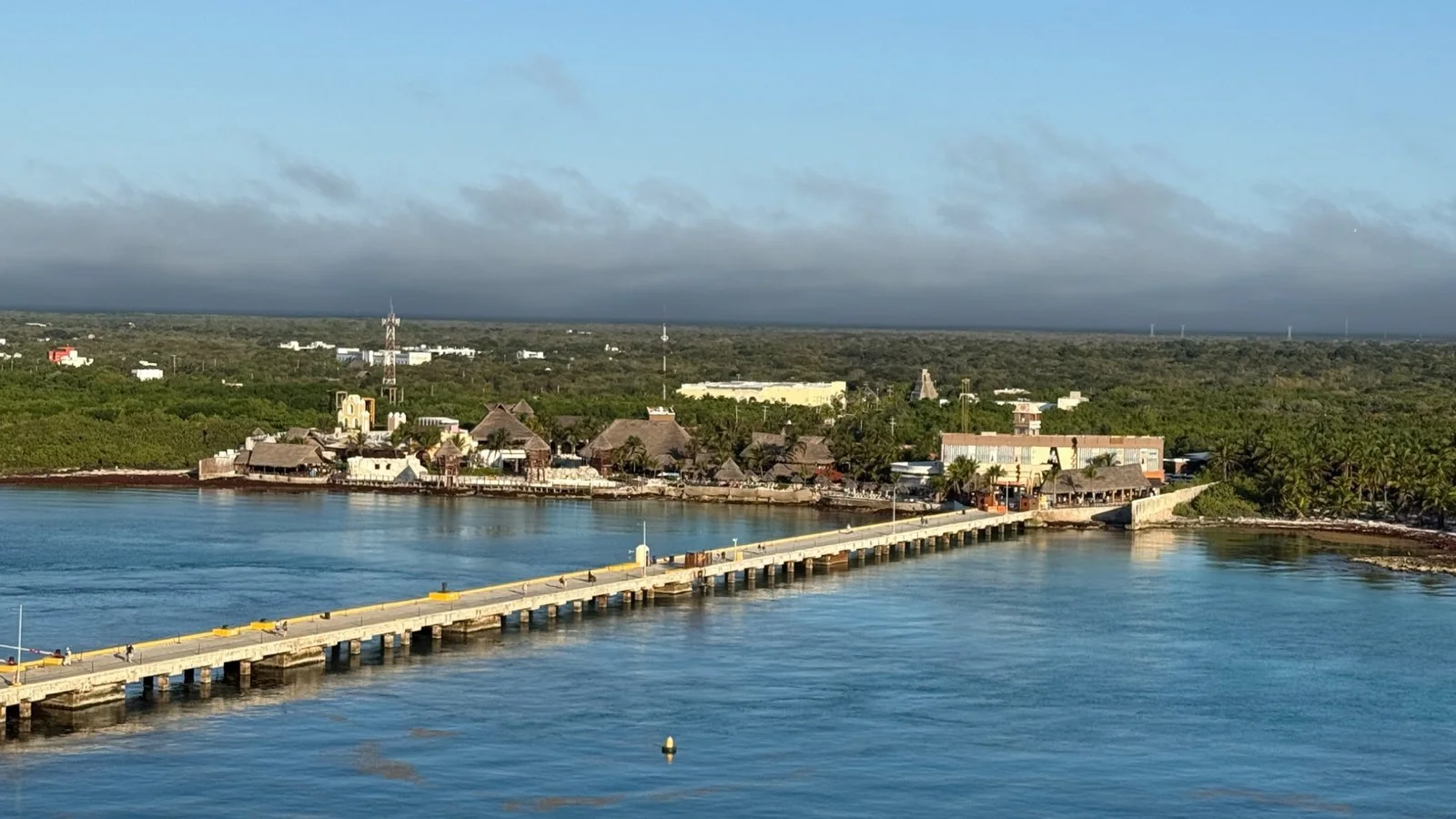 Beachfront bar in Costa Maya, Mexico with wooden structure, white sand and calm Caribbean sea